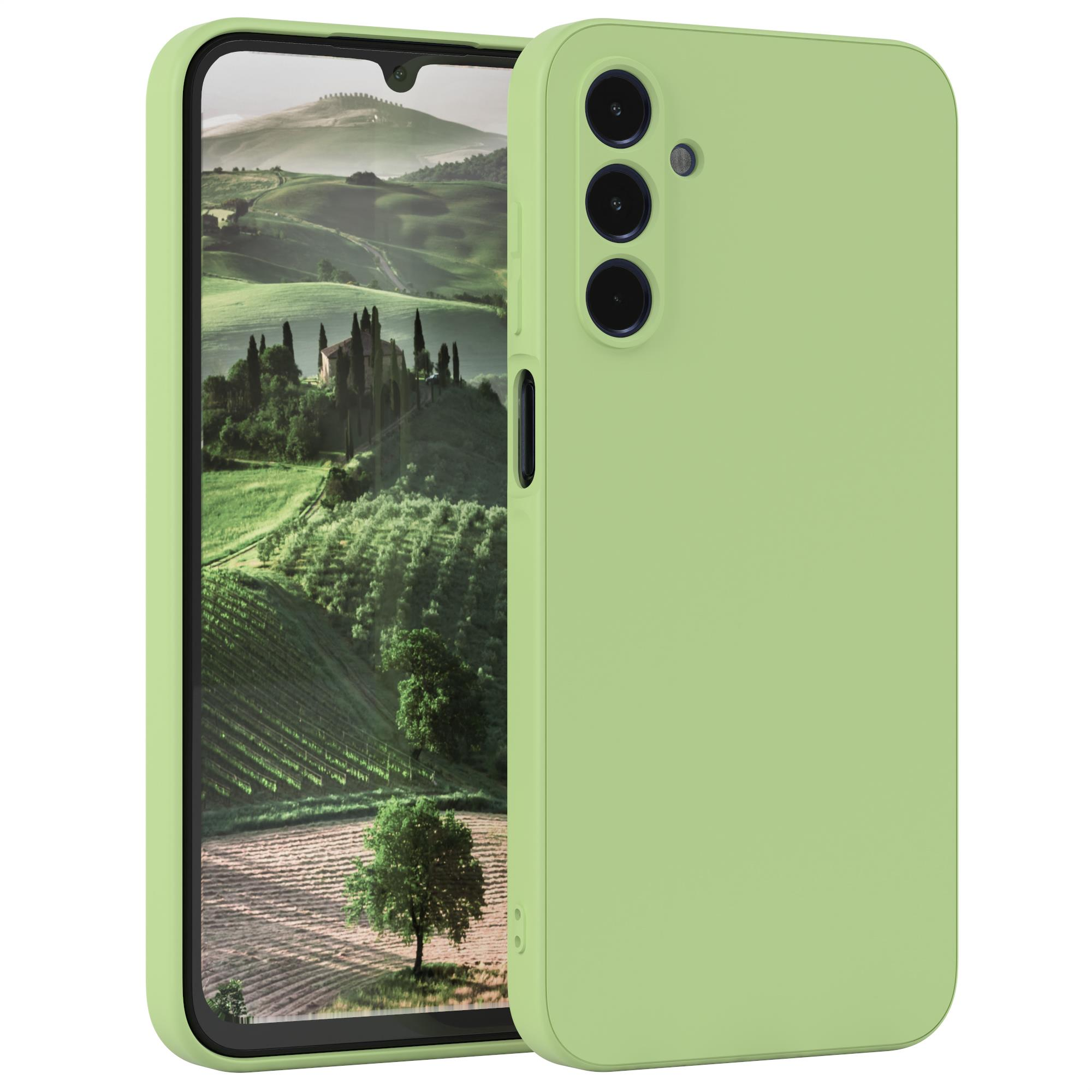 Telefon mit Hülle. Das Telefon ist grün. Der Hintergrund zeigt eine Landschaft mit Bäumen und einem Gebäude.