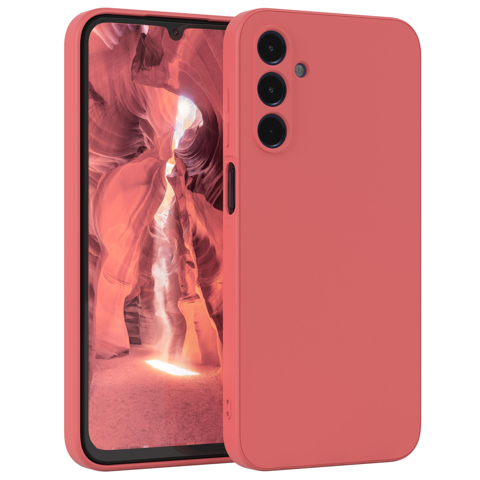 Korallenfarbene Handyhülle auf einem Telefon. Der Hintergrund zeigt einen Canyon.