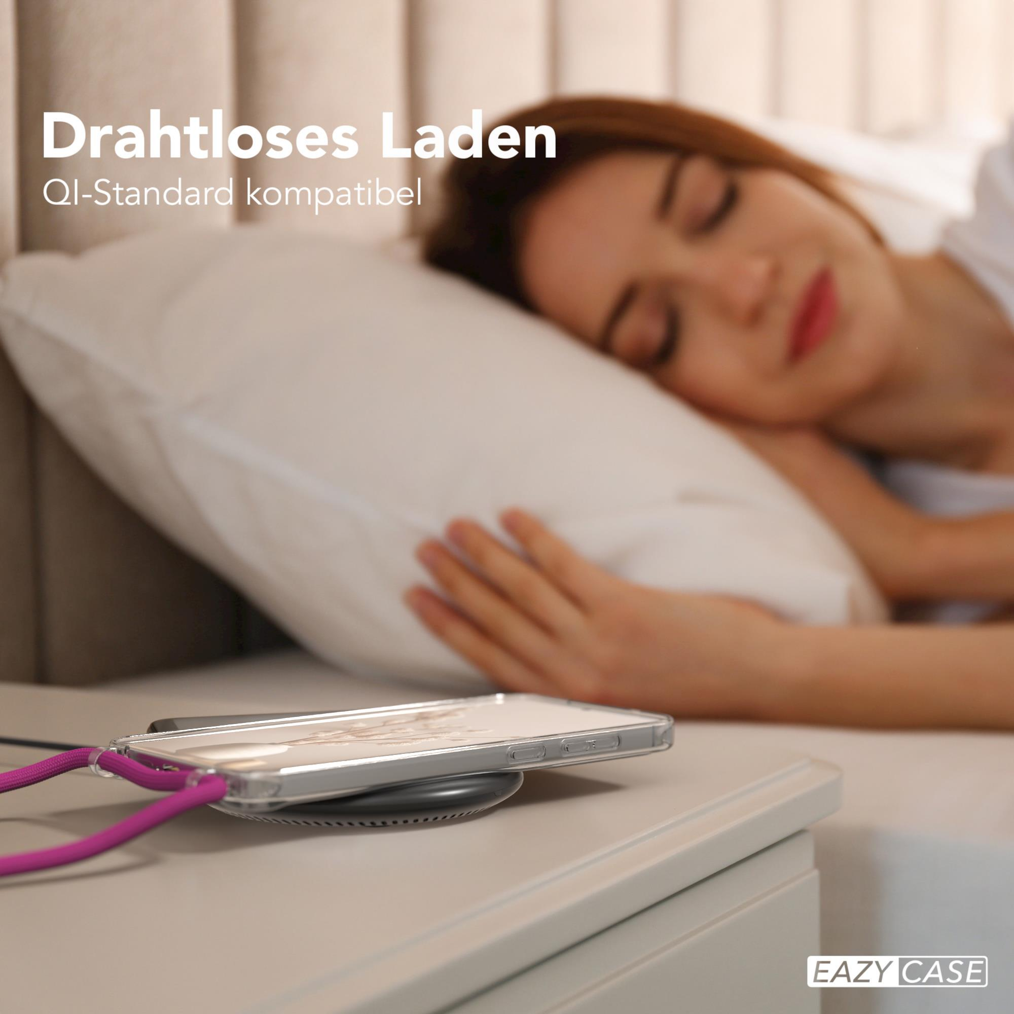 Eine Frau schläft. Ein Telefon wird drahtlos auf einem Nachttisch aufgeladen.