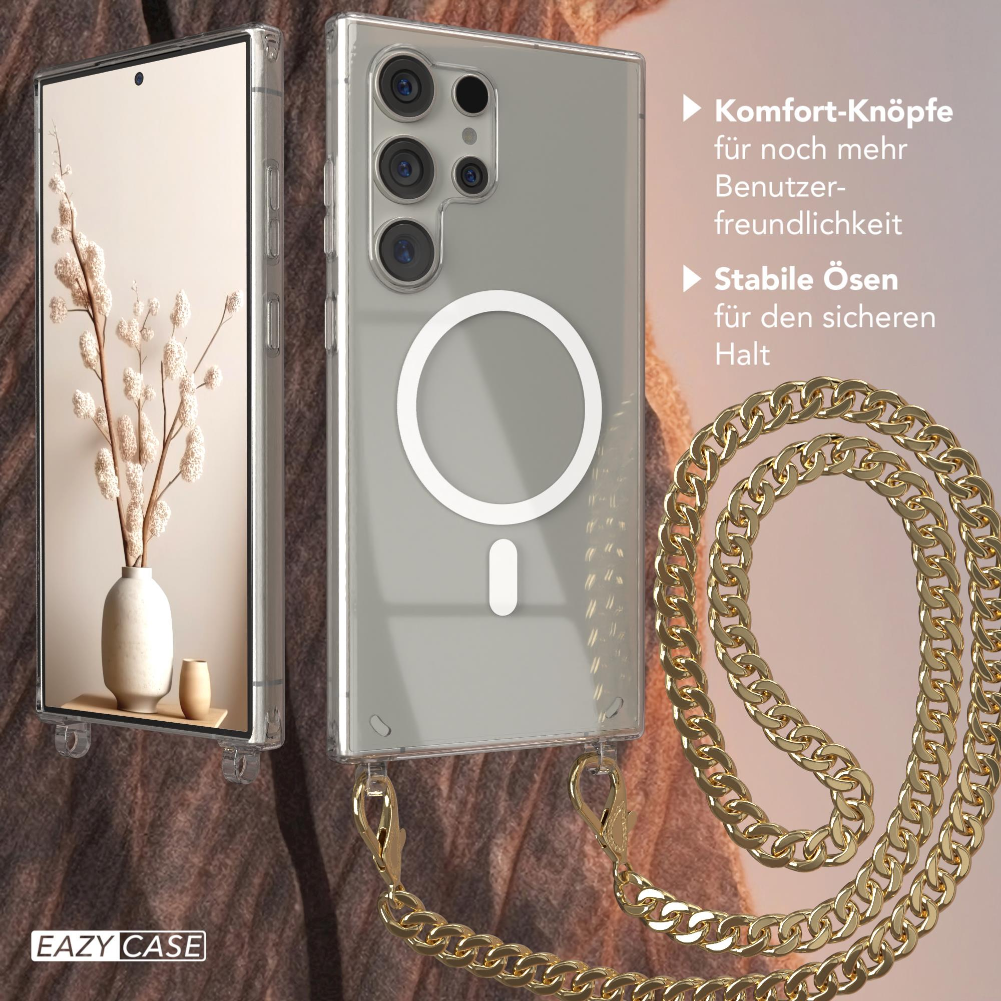 Ein Telefon liegt auf einem Tisch. Eine goldene Kette ist an der Handyhülle befestigt.