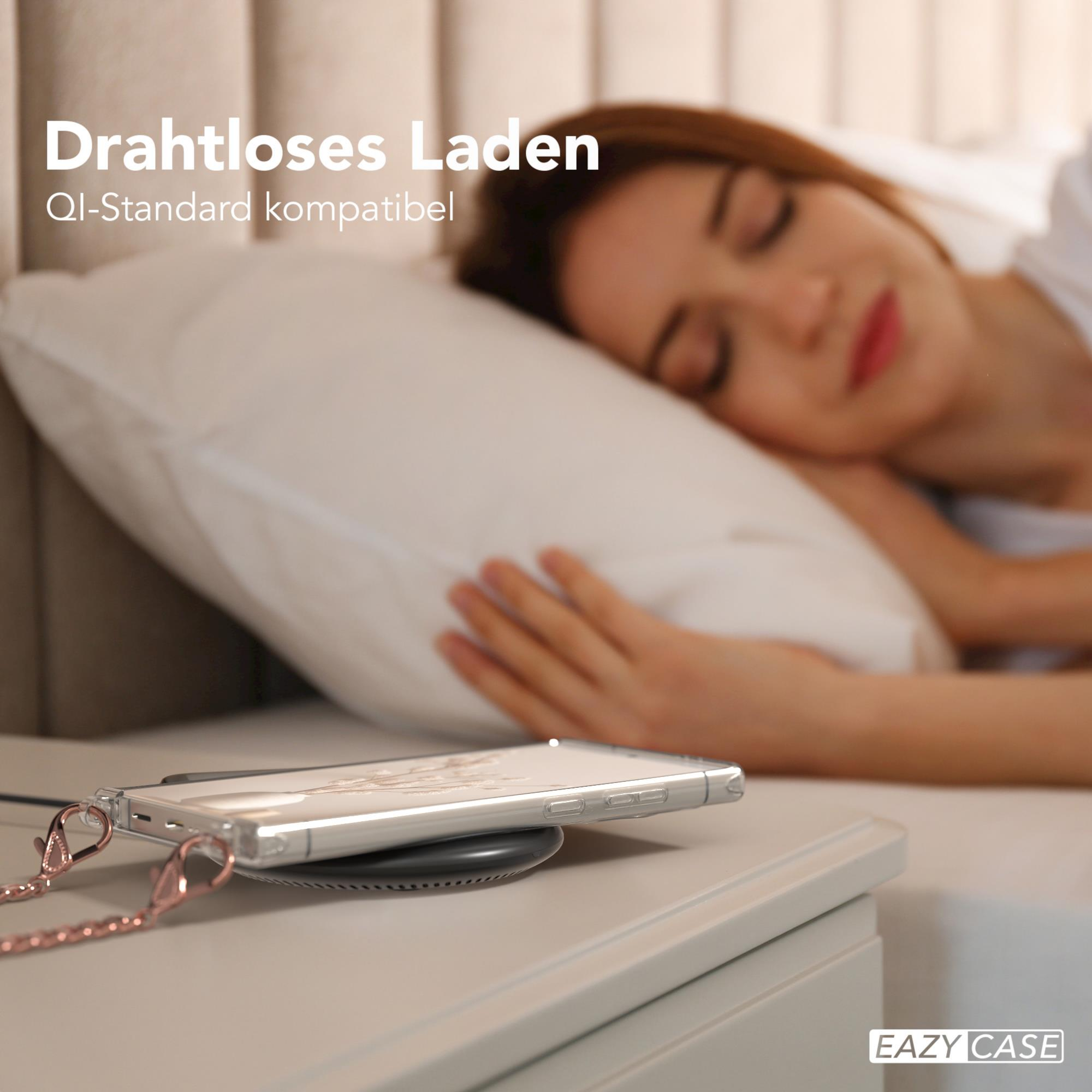 Telefon auf Ladegerät neben schlafender Frau. Text: Kabelloses Laden, Qi-Standard kompatibel.