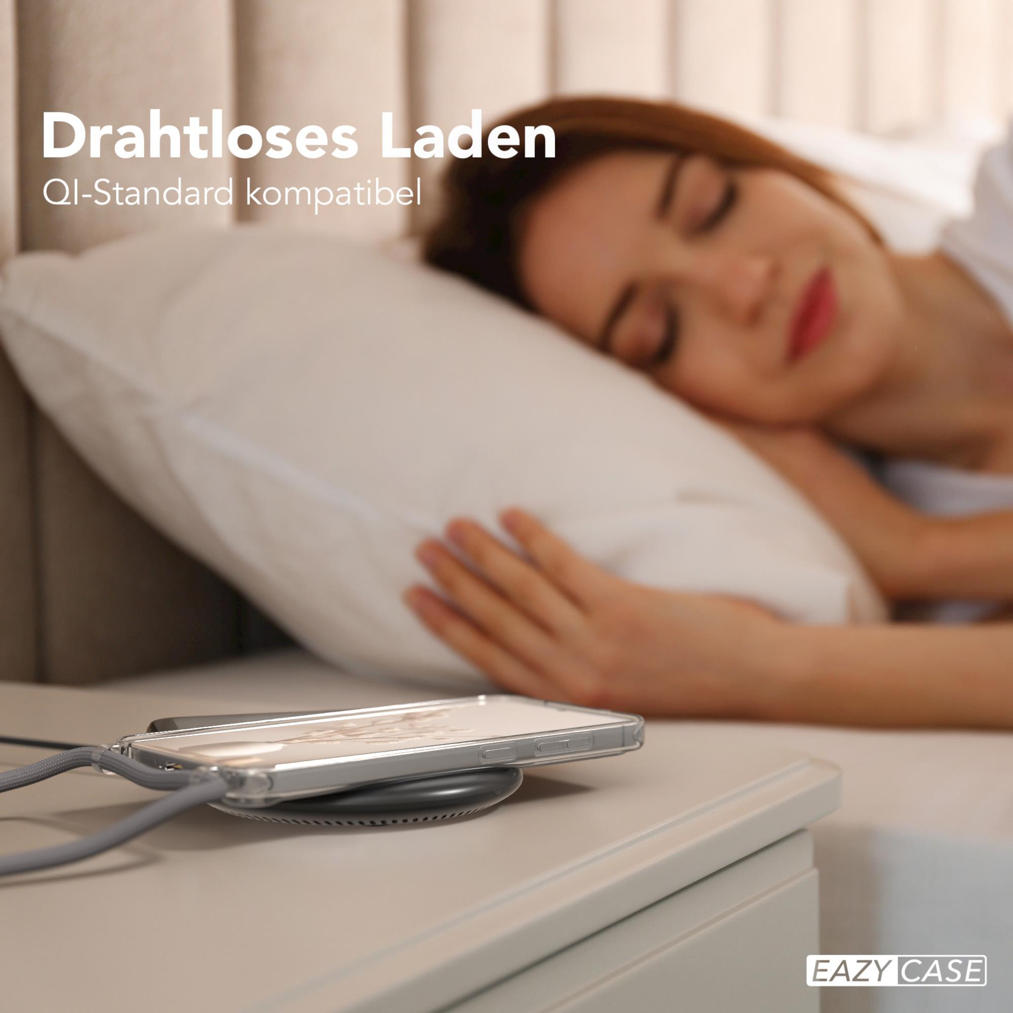 Frau schläft im Bett neben einem Telefon, das drahtlos auf einem Nachttisch geladen wird.