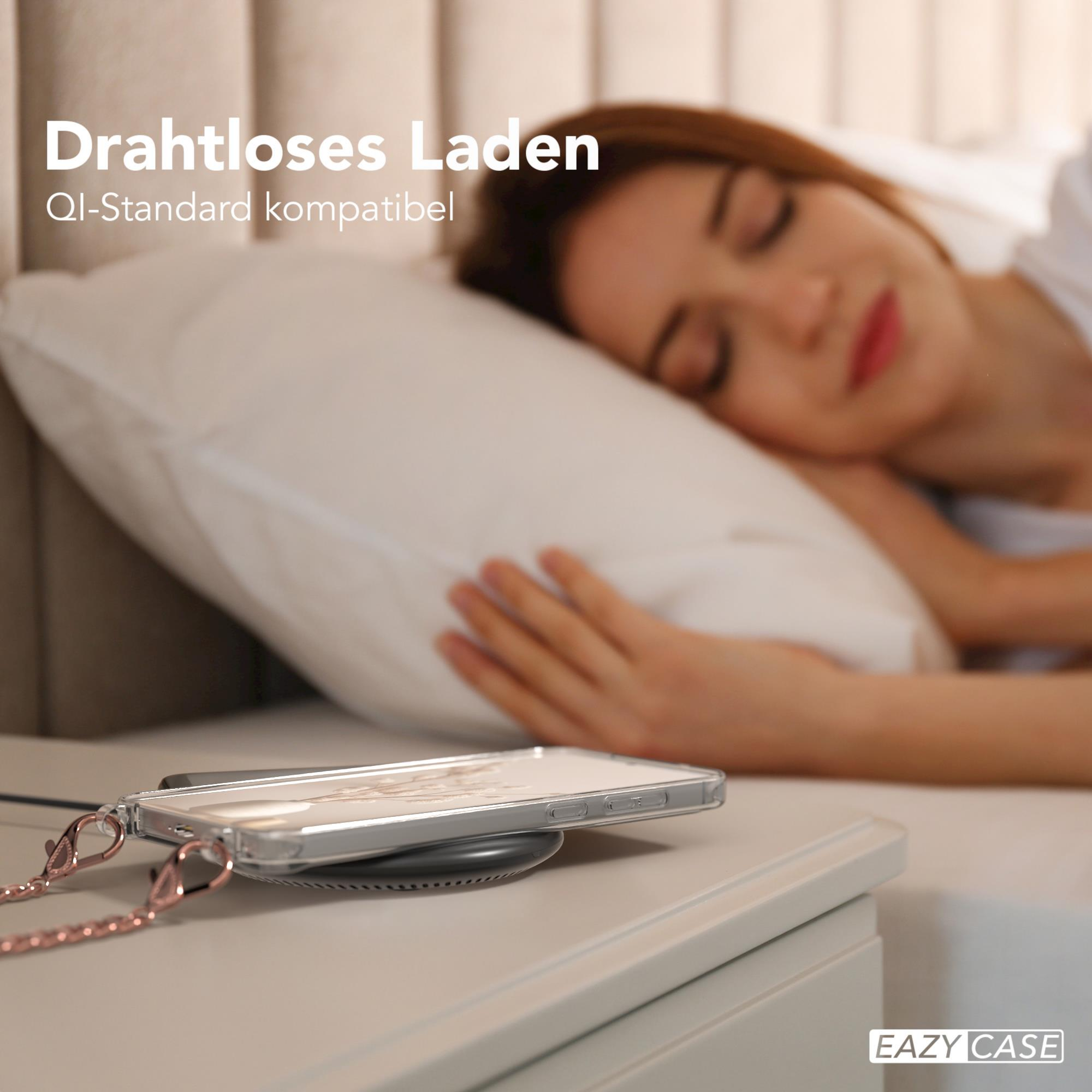 Eine Frau schläft mit ihrem Telefon auf einem kabellosen Ladegerät, mit einer schwarz-roten Handyhülle.