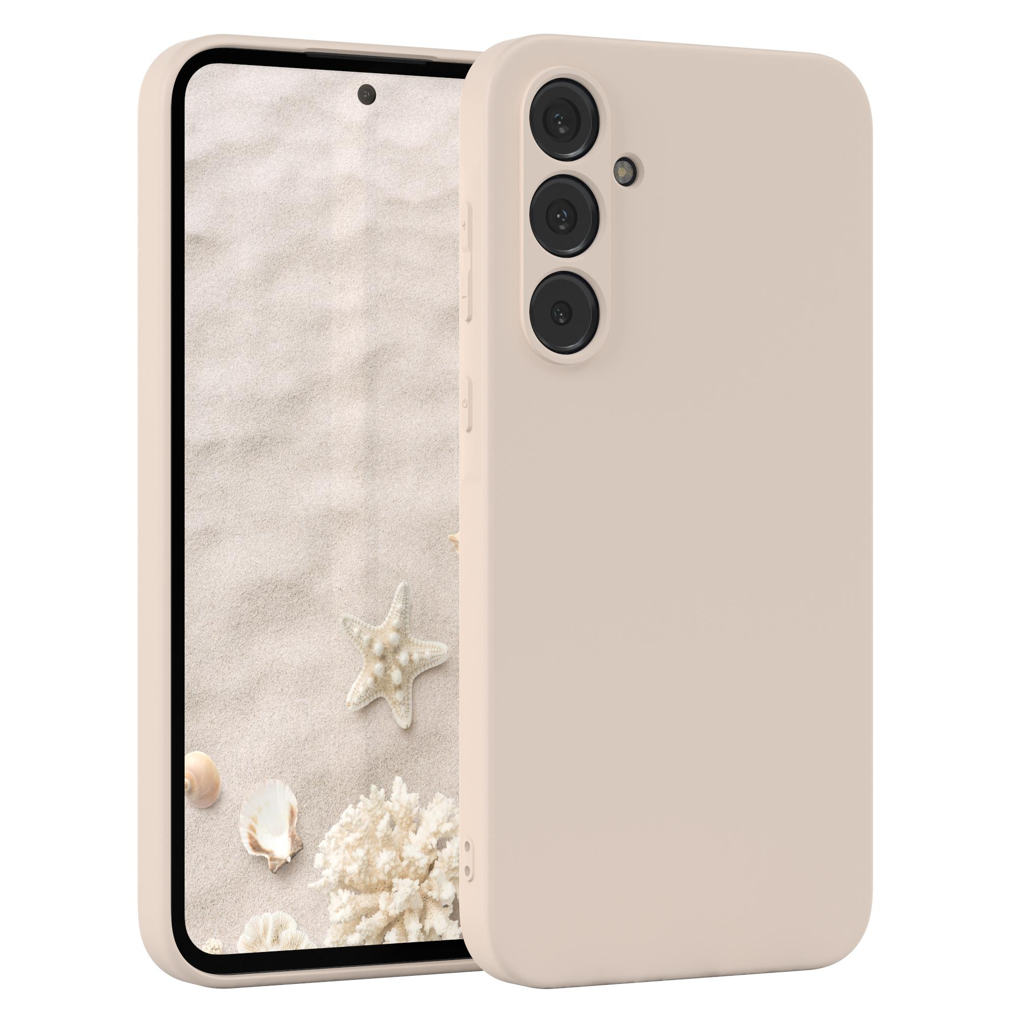 Beiges Telefon mit Hülle. Der Hintergrund ist ein sandiger Strand mit Muscheln und einem Seestern.