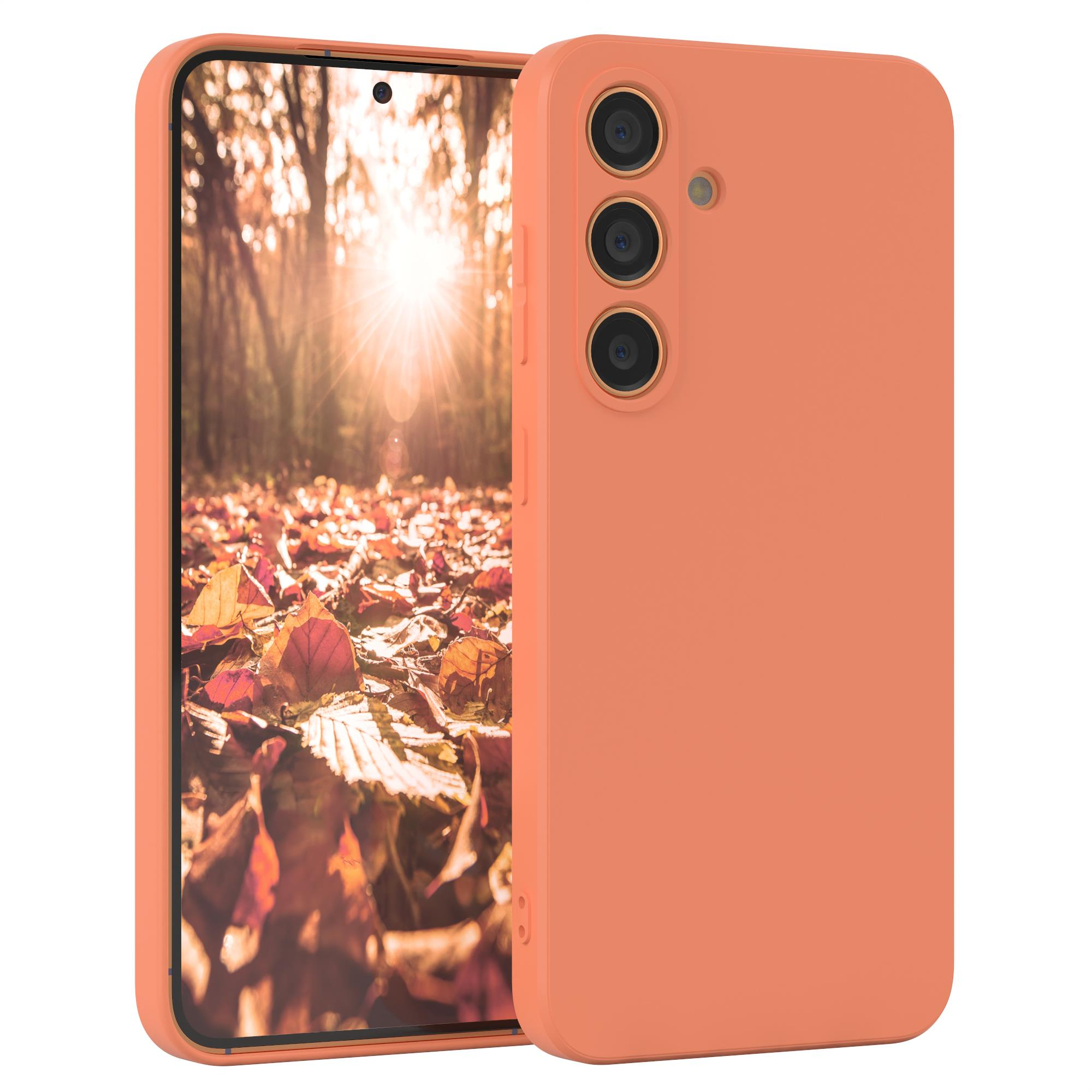 Korallenfarbene Handyhülle auf einem Telefon, das eine Herbstlaubszene zeigt.