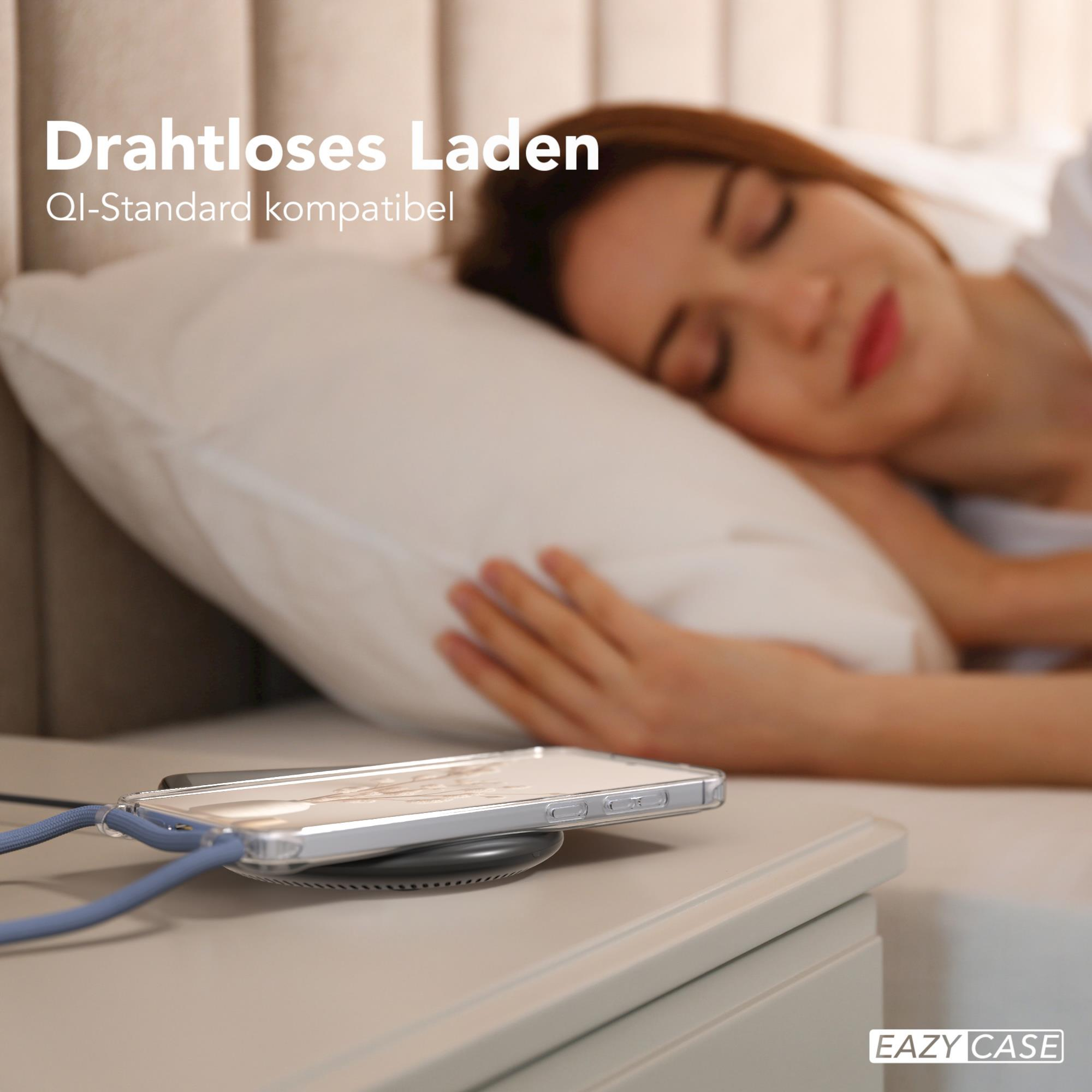 Frau schläft neben einem Telefon, das auf einem kabellosen Ladegerät geladen wird. Das Telefon ist in einer Hülle.