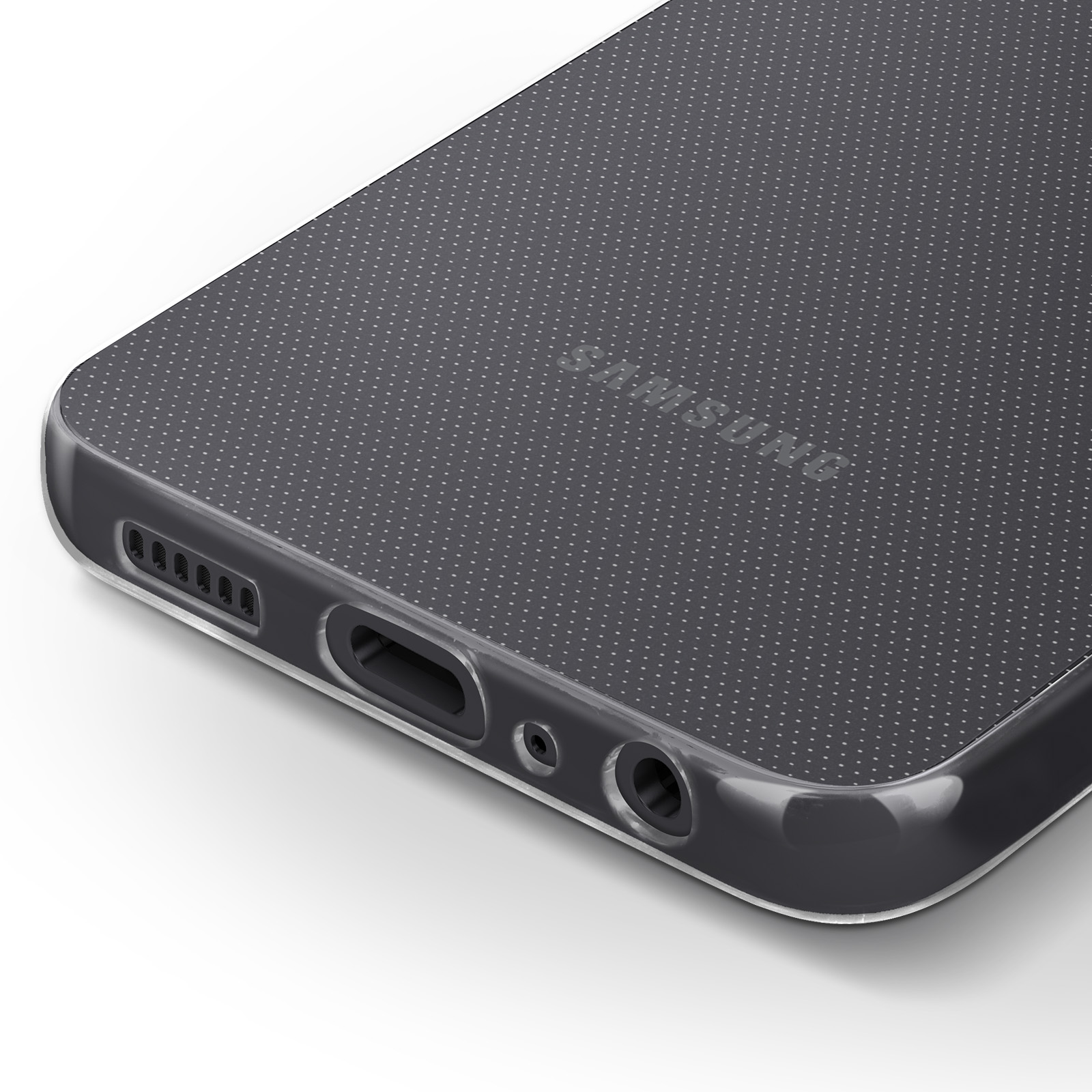 Detalle de la funda del teléfono. Funda negra con patrón de puntos. Superficie blanca.