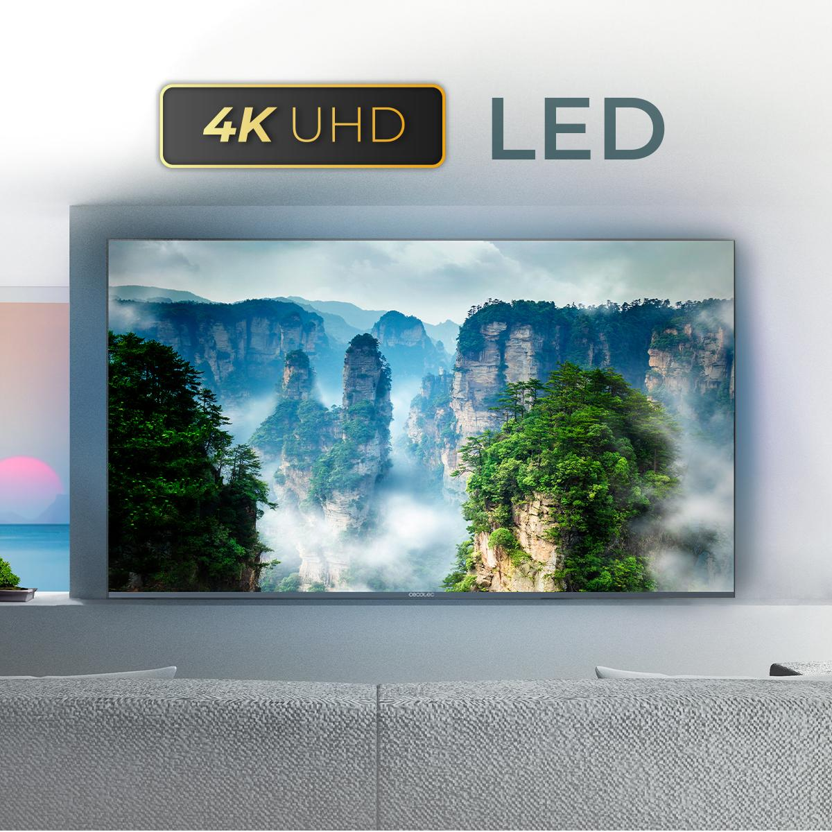 Telewizor wyświetlający piękny krajobraz z górami i chmurami.