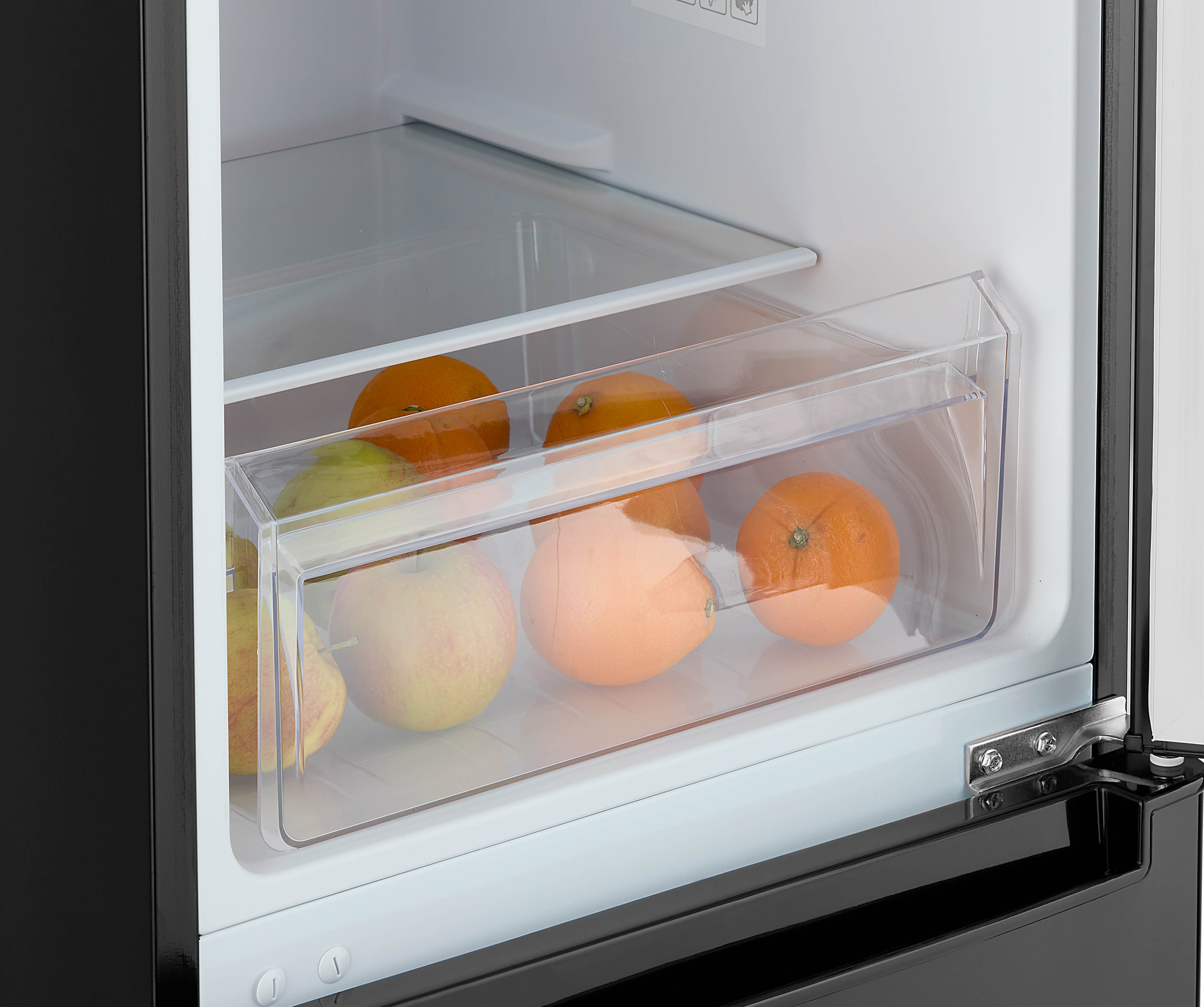 Inside a refrigerator drawer with fruits: oranges, apples, and pears. The drawer is transparent.