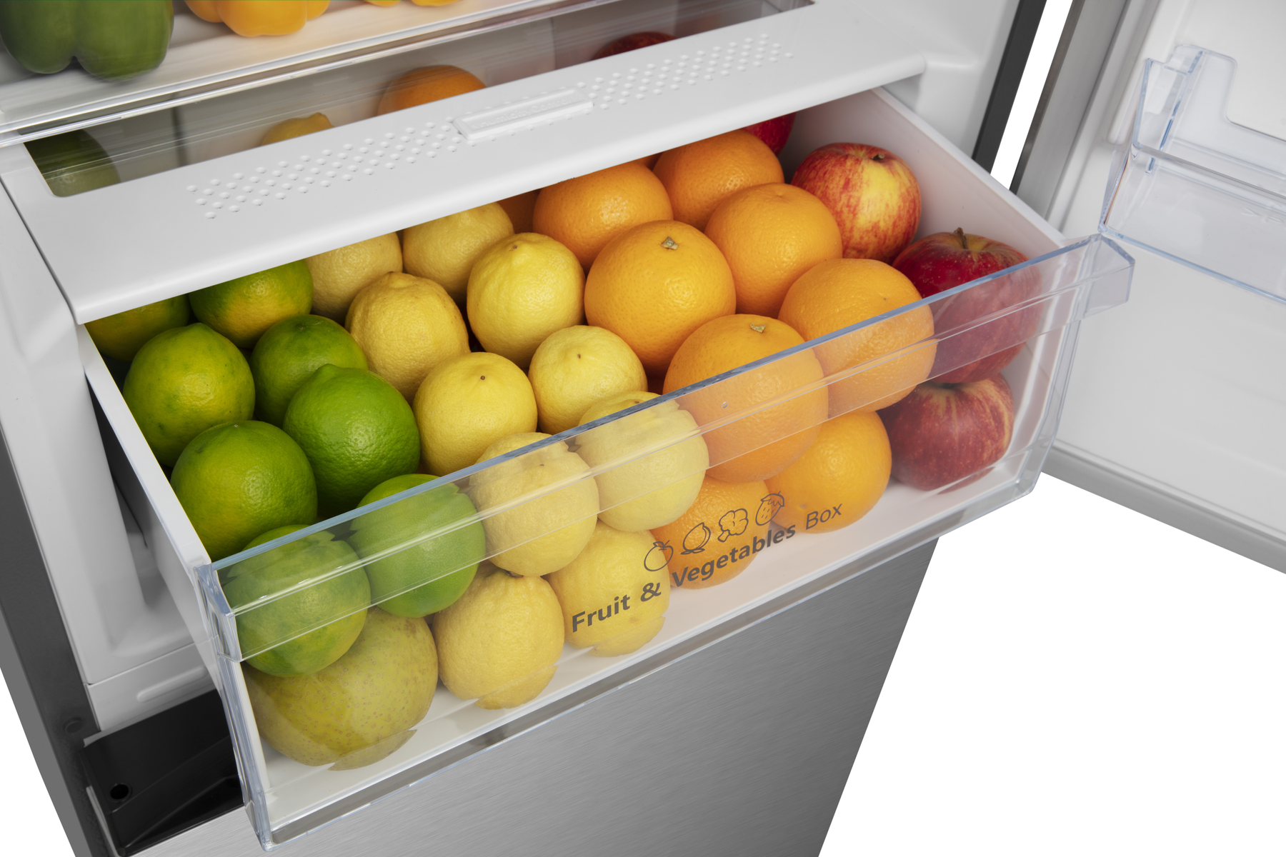 Eine Kühlschublade voller Früchte. Zitronen, Limetten, Orangen und Äpfel sind sichtbar.