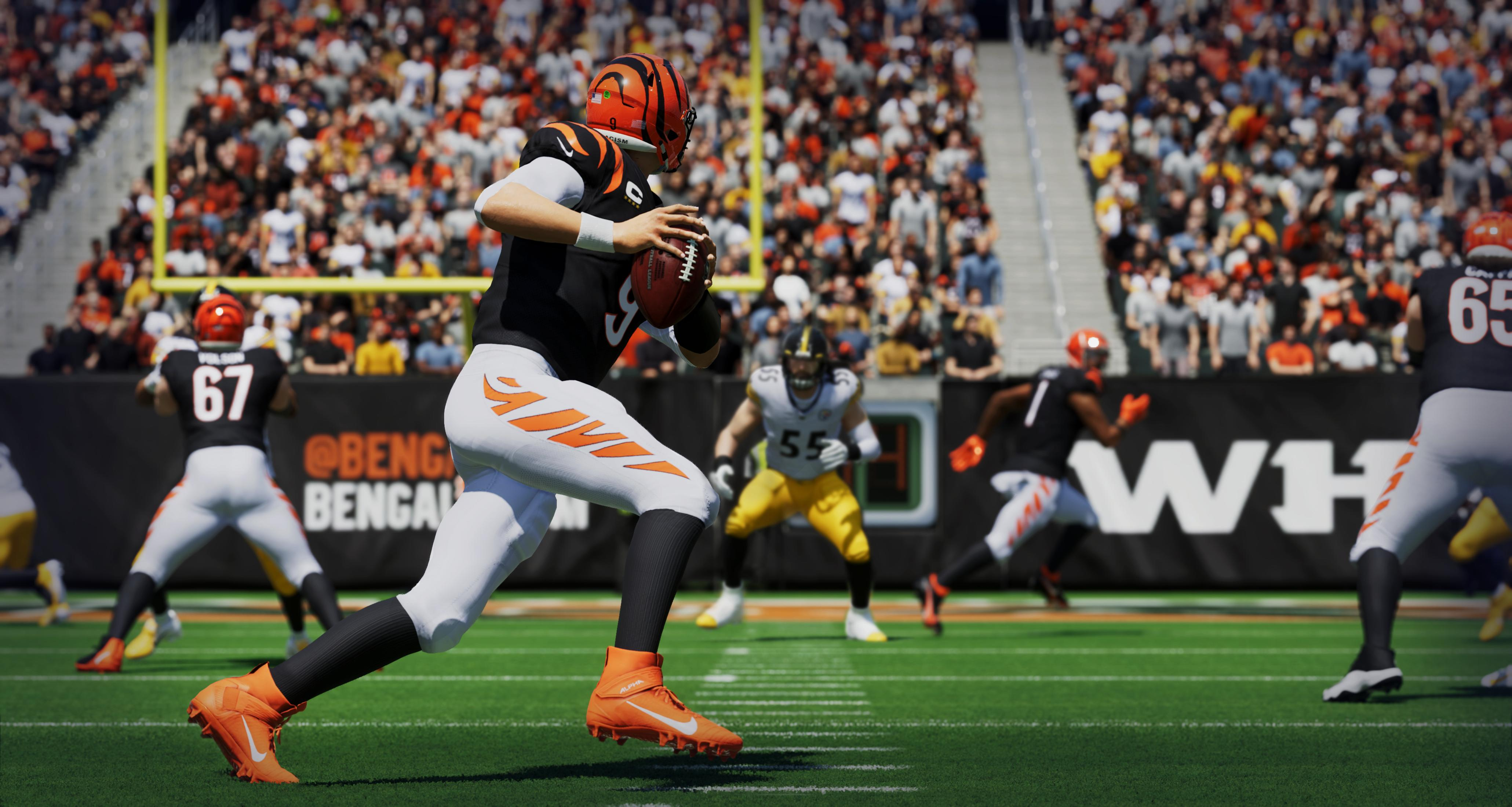 Footballspieler in Aktion, Bengals-Uniform, auf grünem Feld, Publikum im Hintergrund.