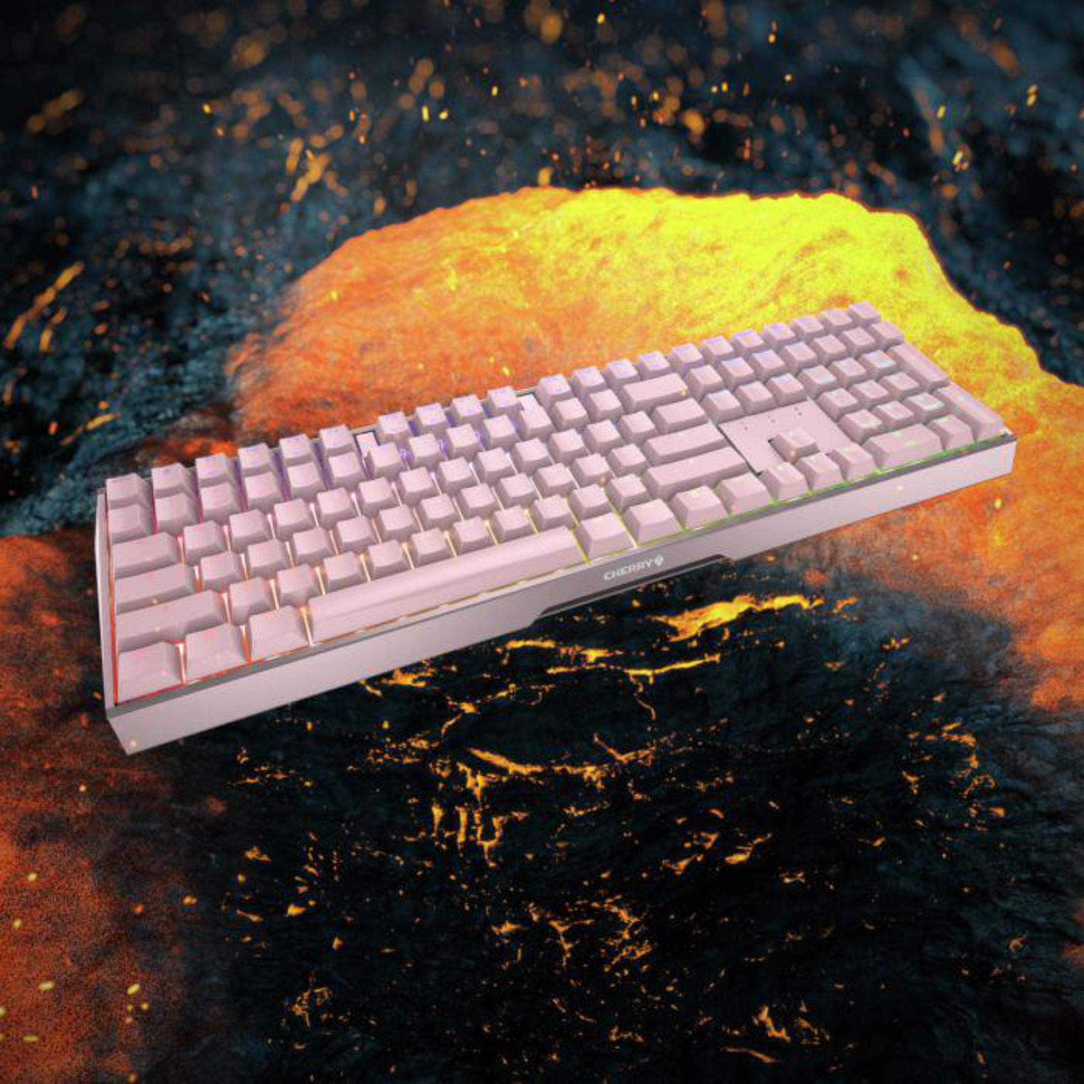 Różowa klawiatura na tle lawy i stopionej skały, z logo CHERRY.
