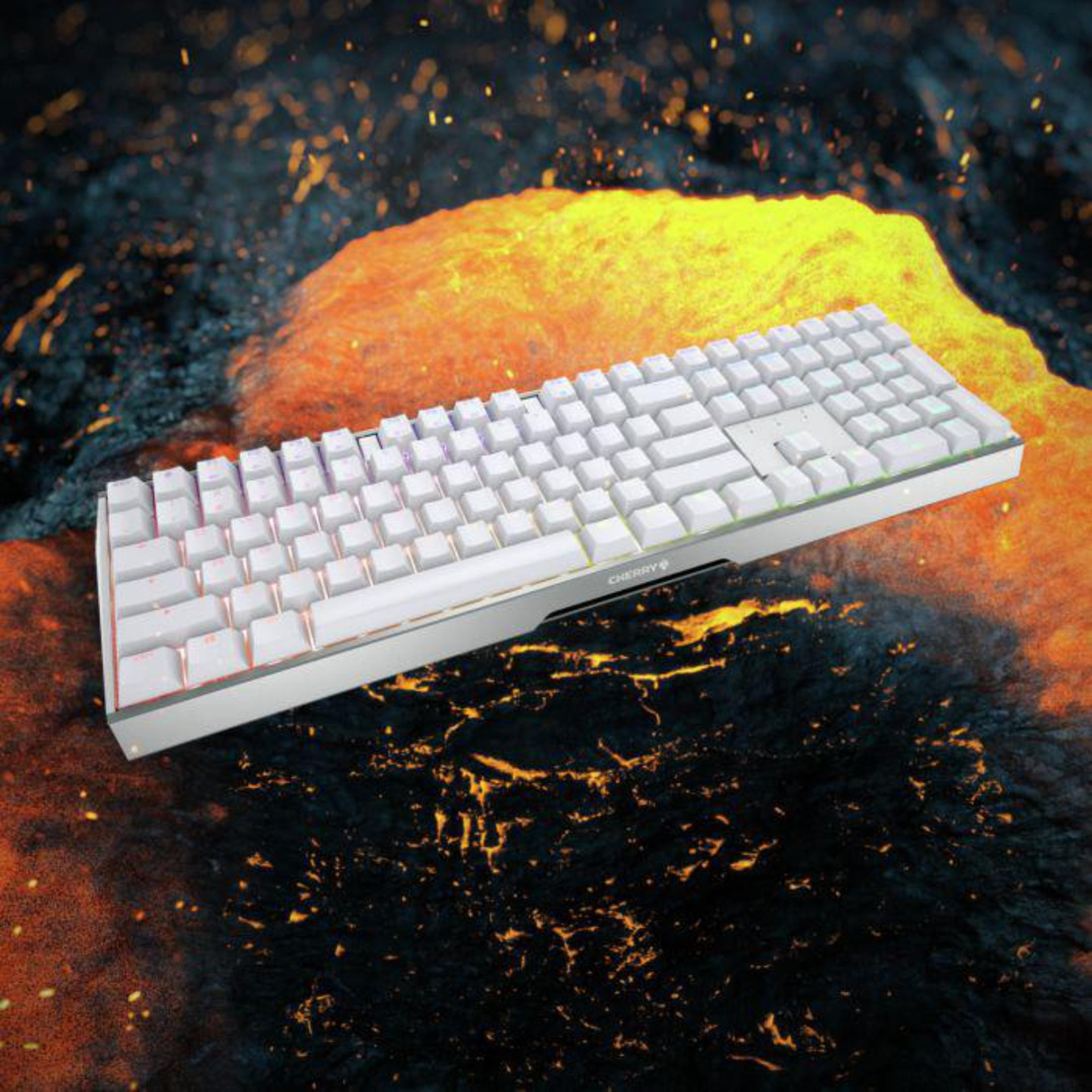 Biała klawiatura na powierzchni przypominającej lawę. Klawiatura ma podświetlenie RGB.