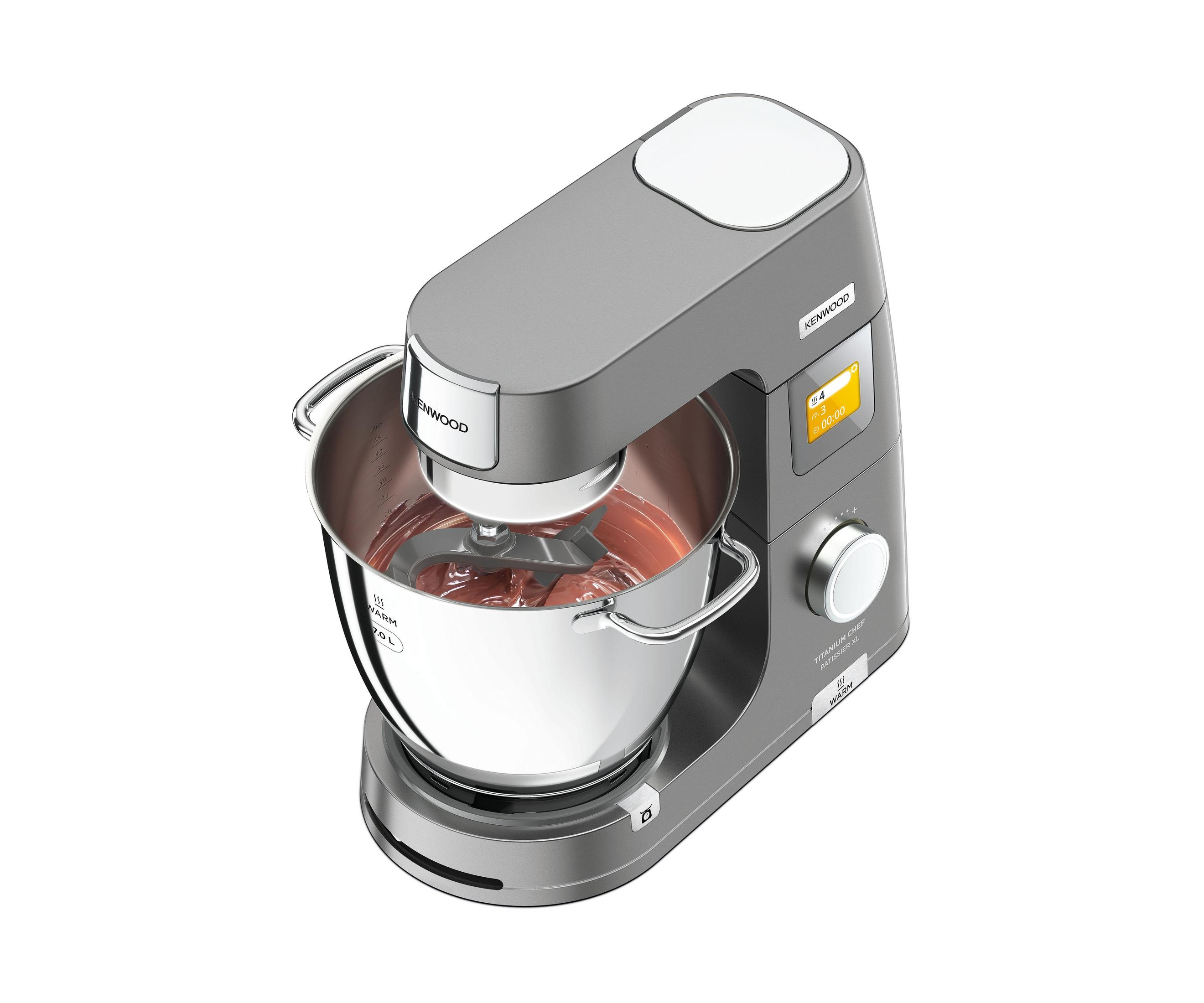 A gray Kenwood stand mixer with a bowl of reddish batter, isolated on white.