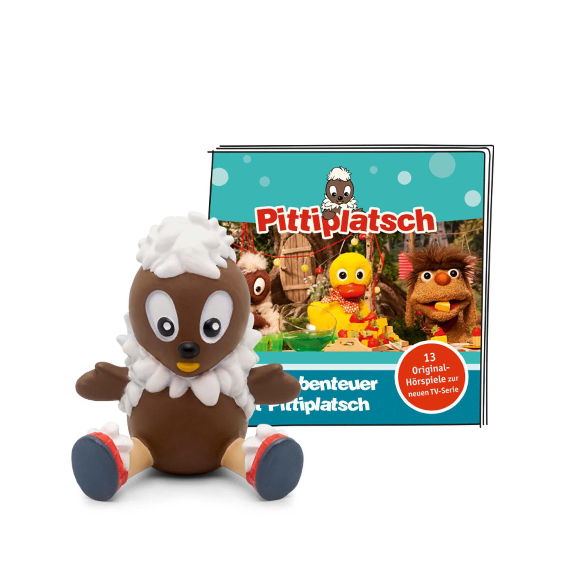 Eine Spielzeugfigur mit einem Buch. Die Figur ist braun mit weißem Fell.