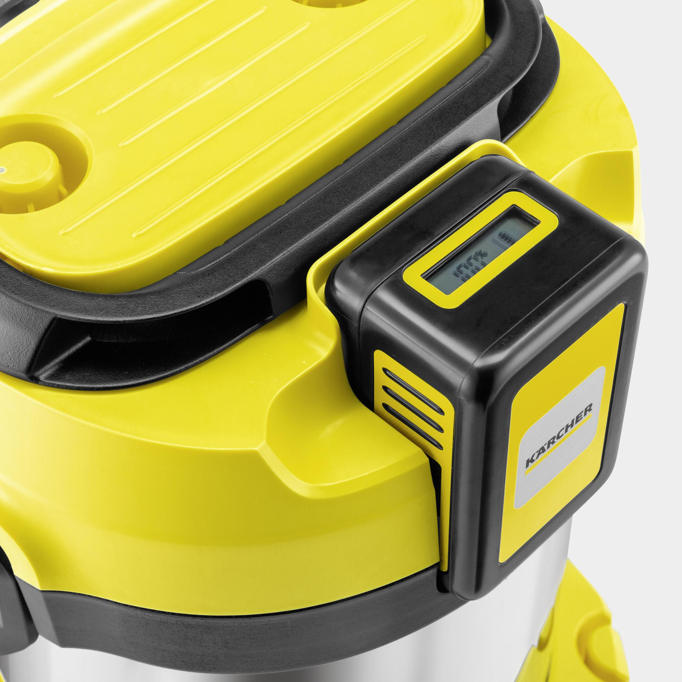 Close-up of a yellow and black vacuum cleaner with a digital display.