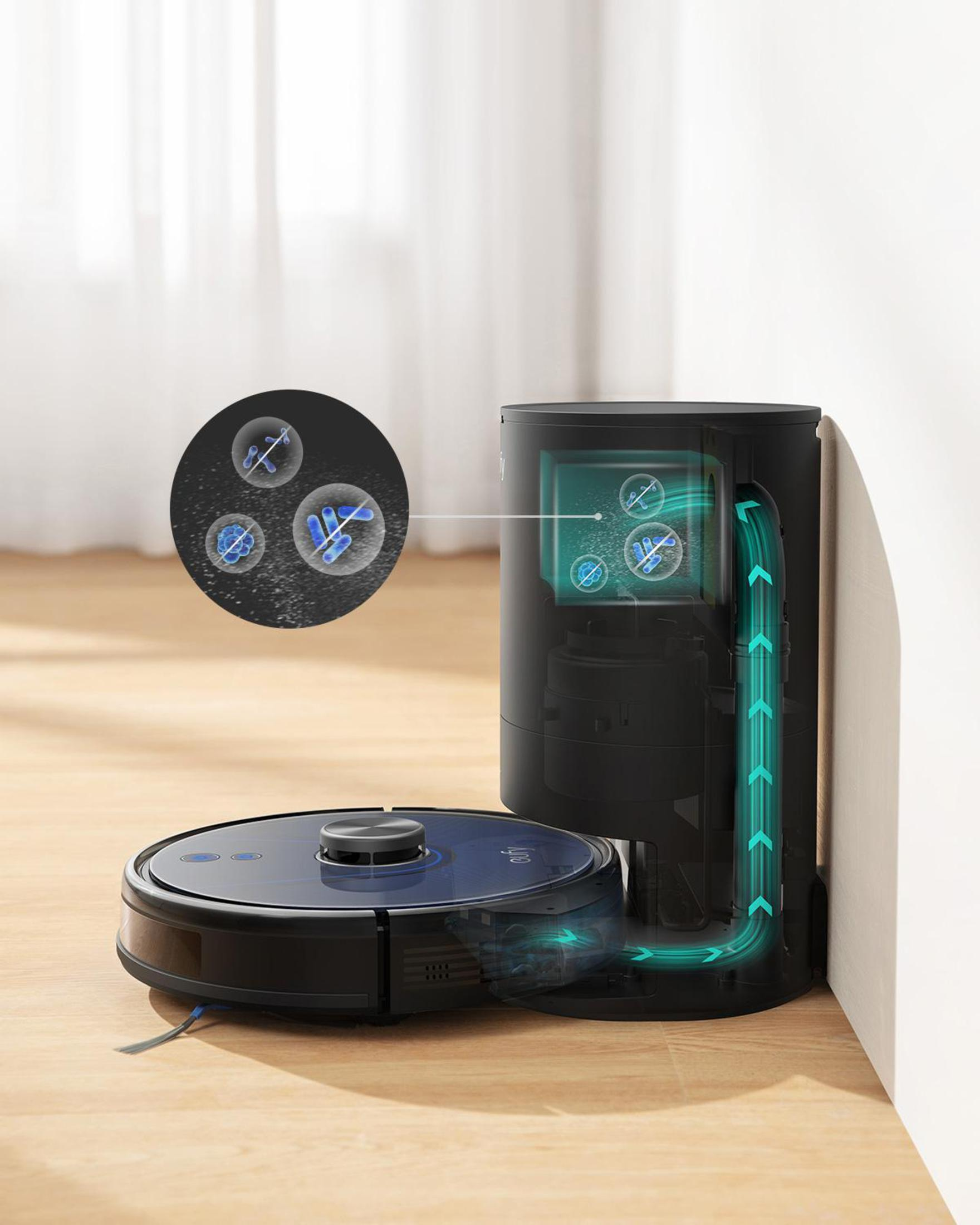 Robot odkurzający i jego stacja ładująca. Strzałki pokazują przepływ powietrza. Zbliżenie na elementy wewnętrzne.