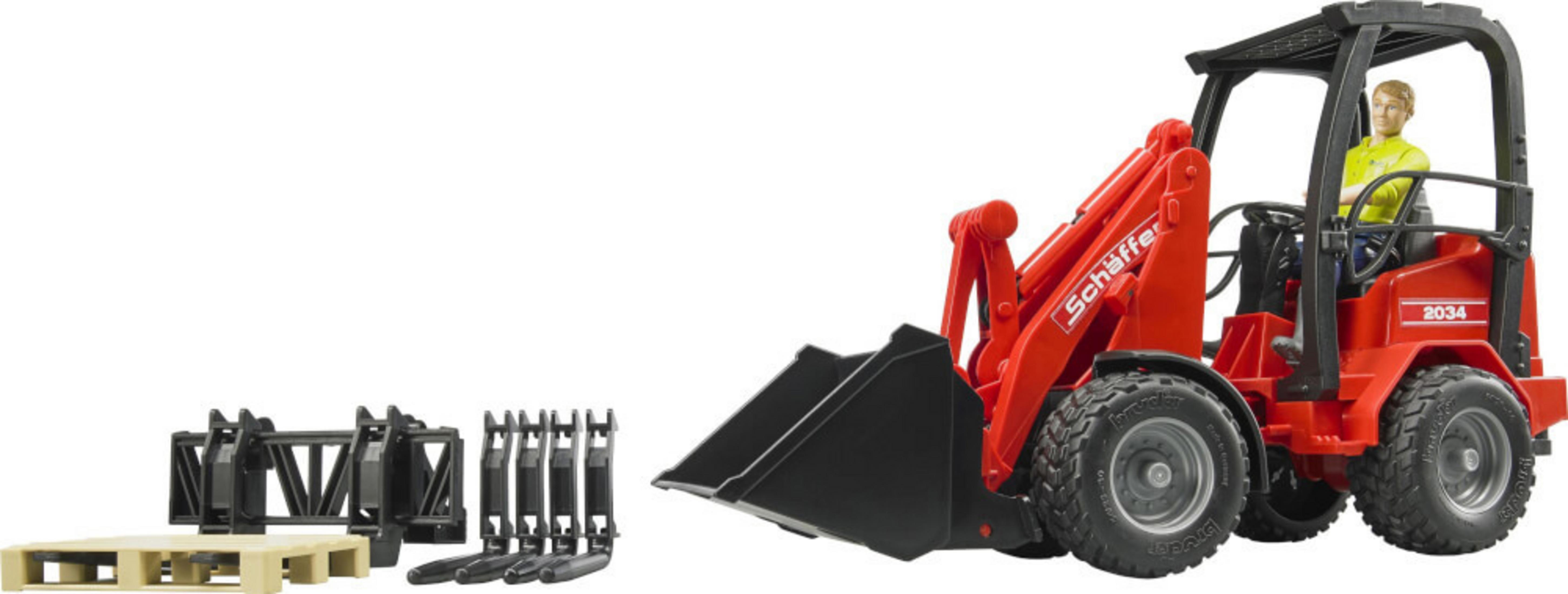 Czerwona zabawka ładowarka czołowa z mężczyzną za kierownicą. Białe tło.