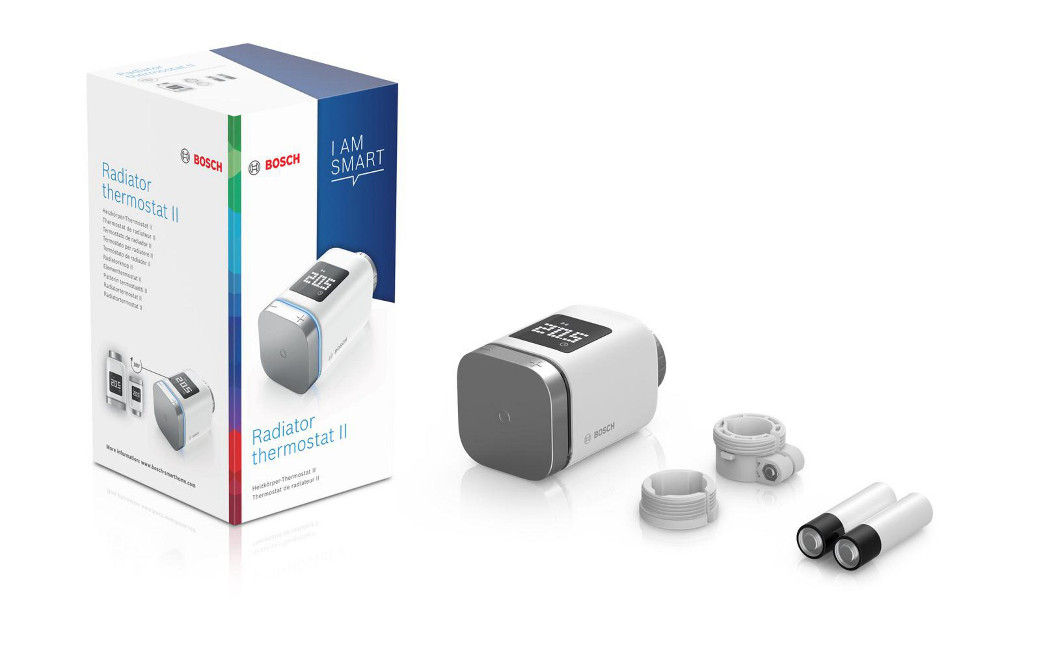 Bosch Heizkörperthermostat II und Verpackung. Das Thermostat ist weiß, mit Digitalanzeige 20,5.