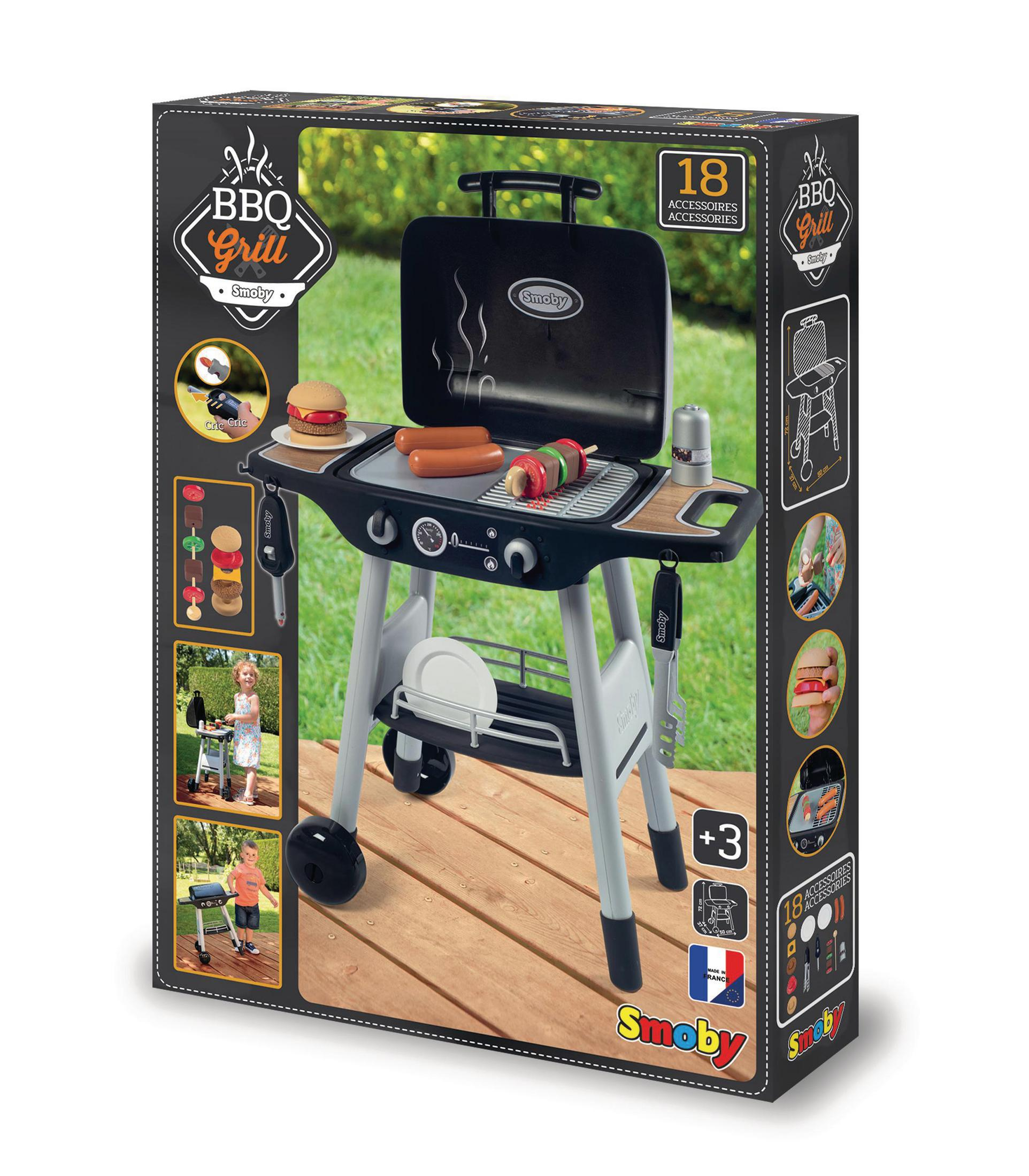 Spielzeug-BBQ-Grill in einer Box, mit Essen und Zubehör. Enthält einen Burger, Würstchen und Gemüse.