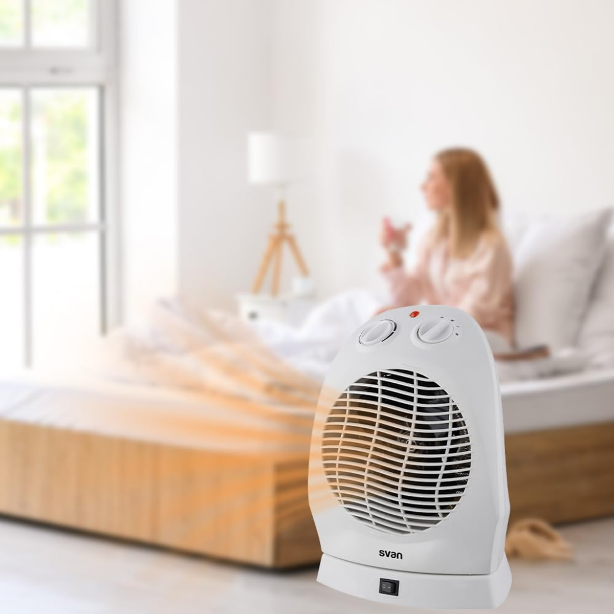 Calentador eléctrico blanco soplando aire caliente. Una mujer sentada en una cama.