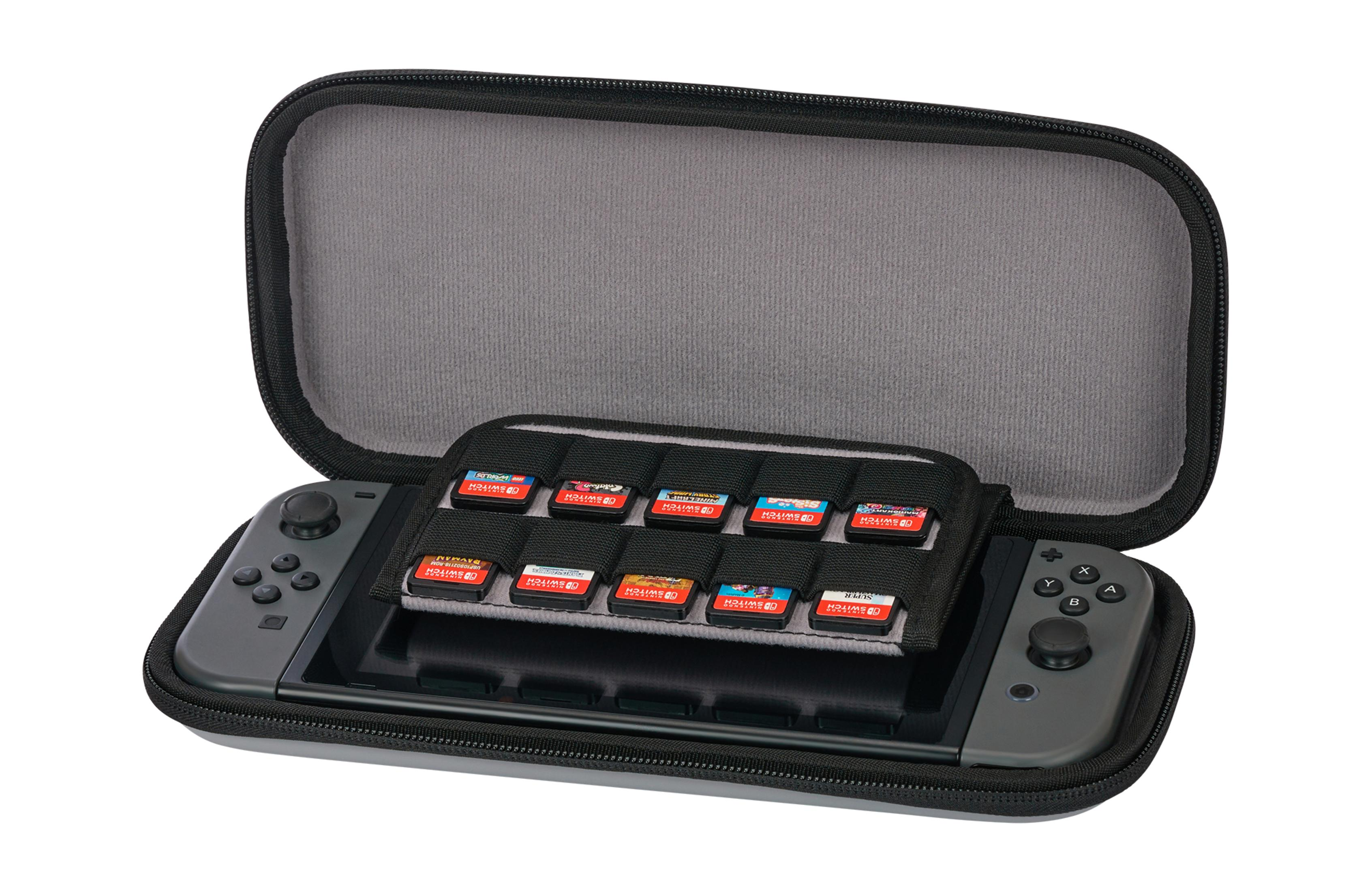 Una consola Switch gris en un estuche con cartuchos de juego en un soporte.