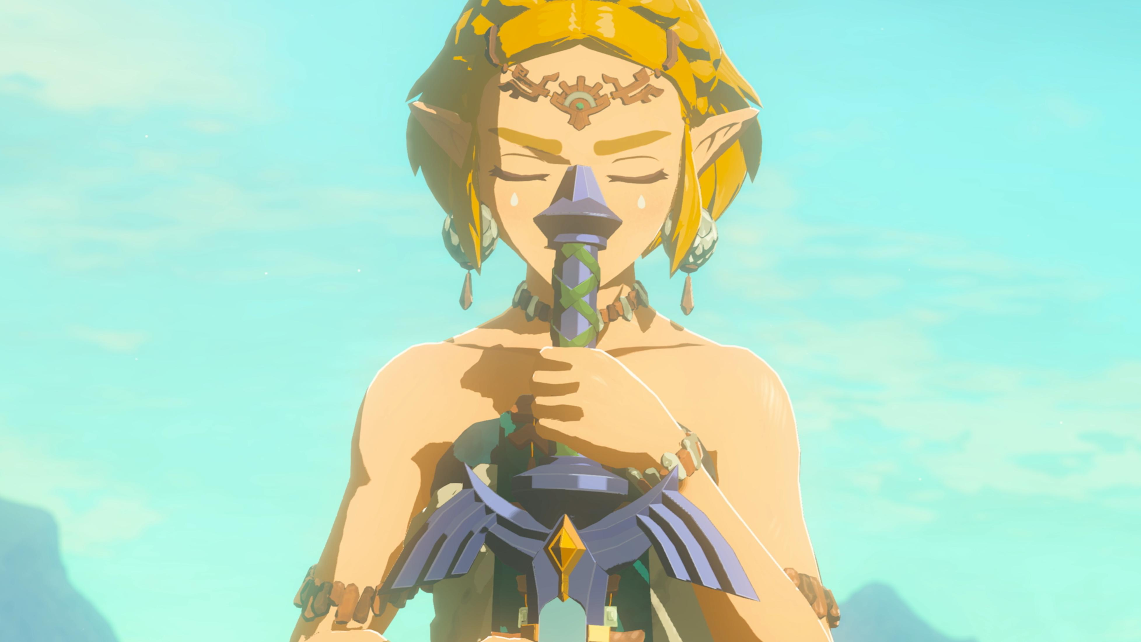 Zelda da Breath of the Wild, impugna la Spada Suprema, con le lacrime agli occhi.