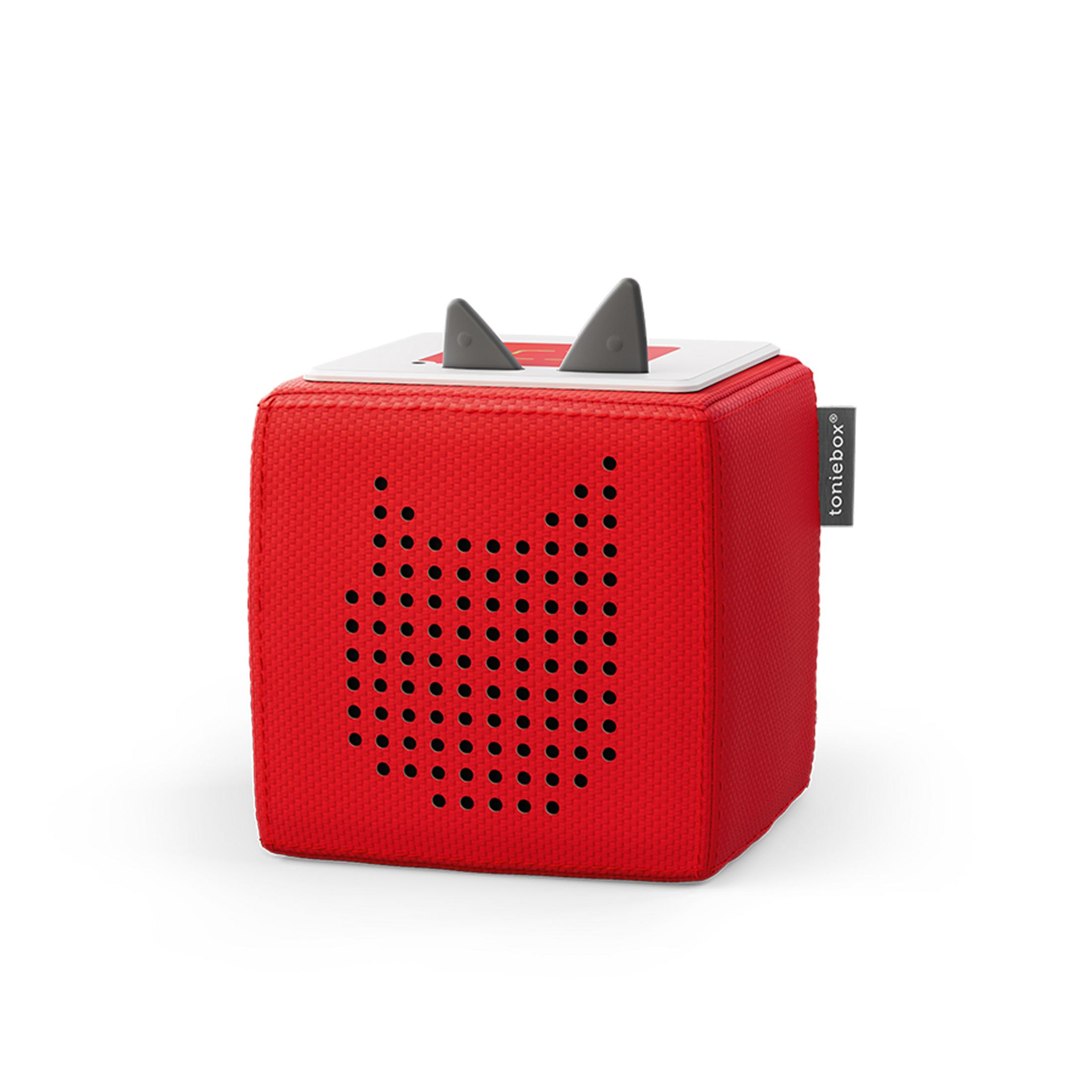 Un altavoz Toniebox cuadrado rojo con dos orejas grises en la parte superior, aislado.