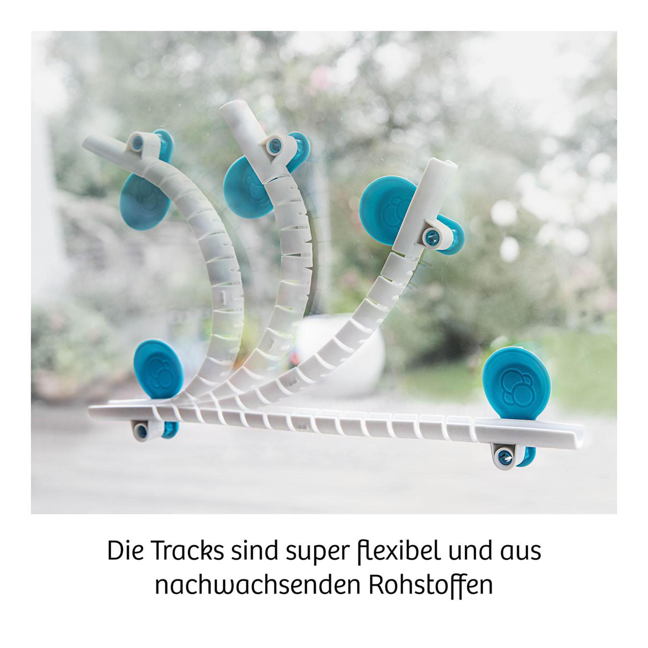 Drei flexible, weiße Schienen mit blauen Saugnäpfen vor verschwommenem Fensterhintergrund.