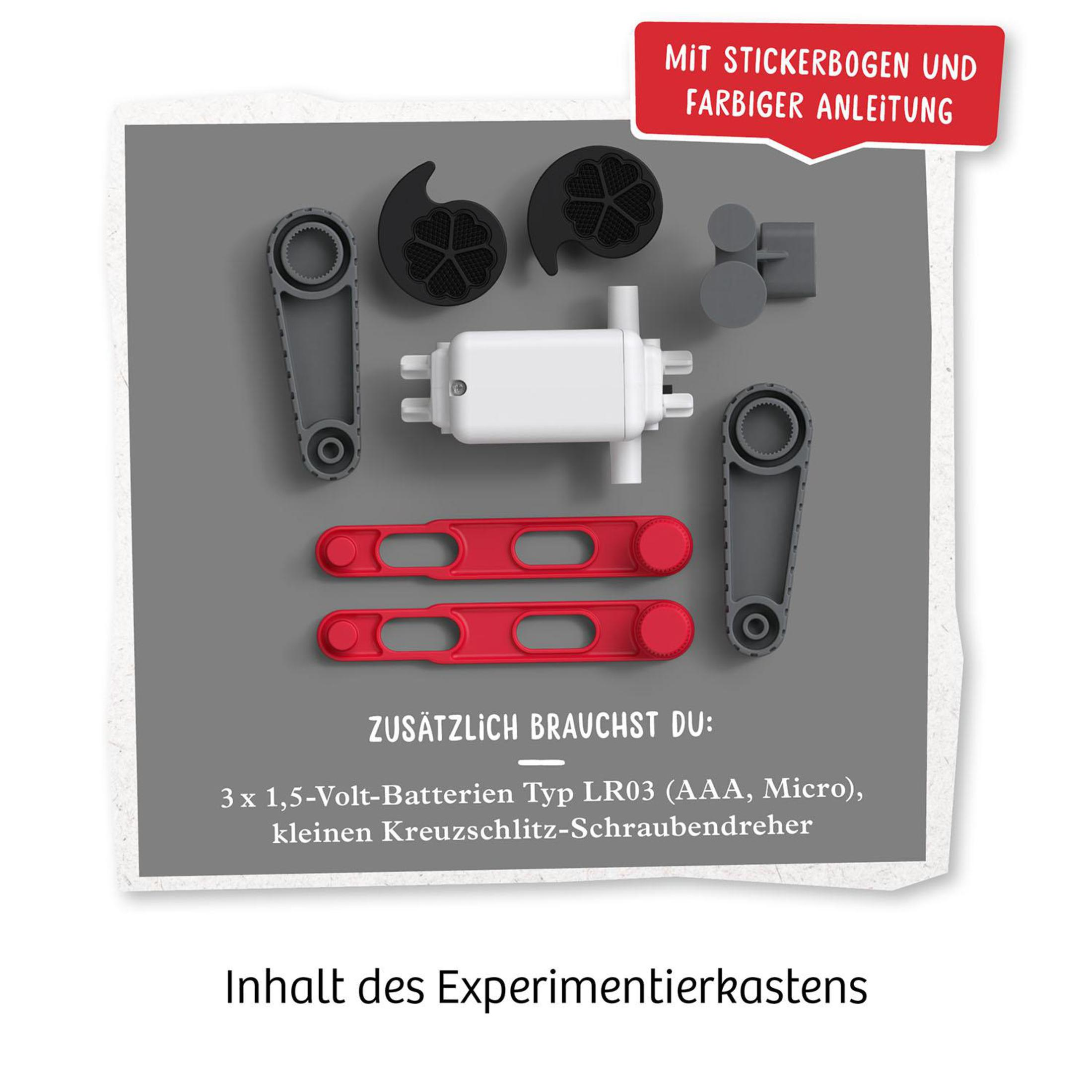 Pièces pour un kit d'expériences : divers composants plastiques, tiges rouges et base blanche.