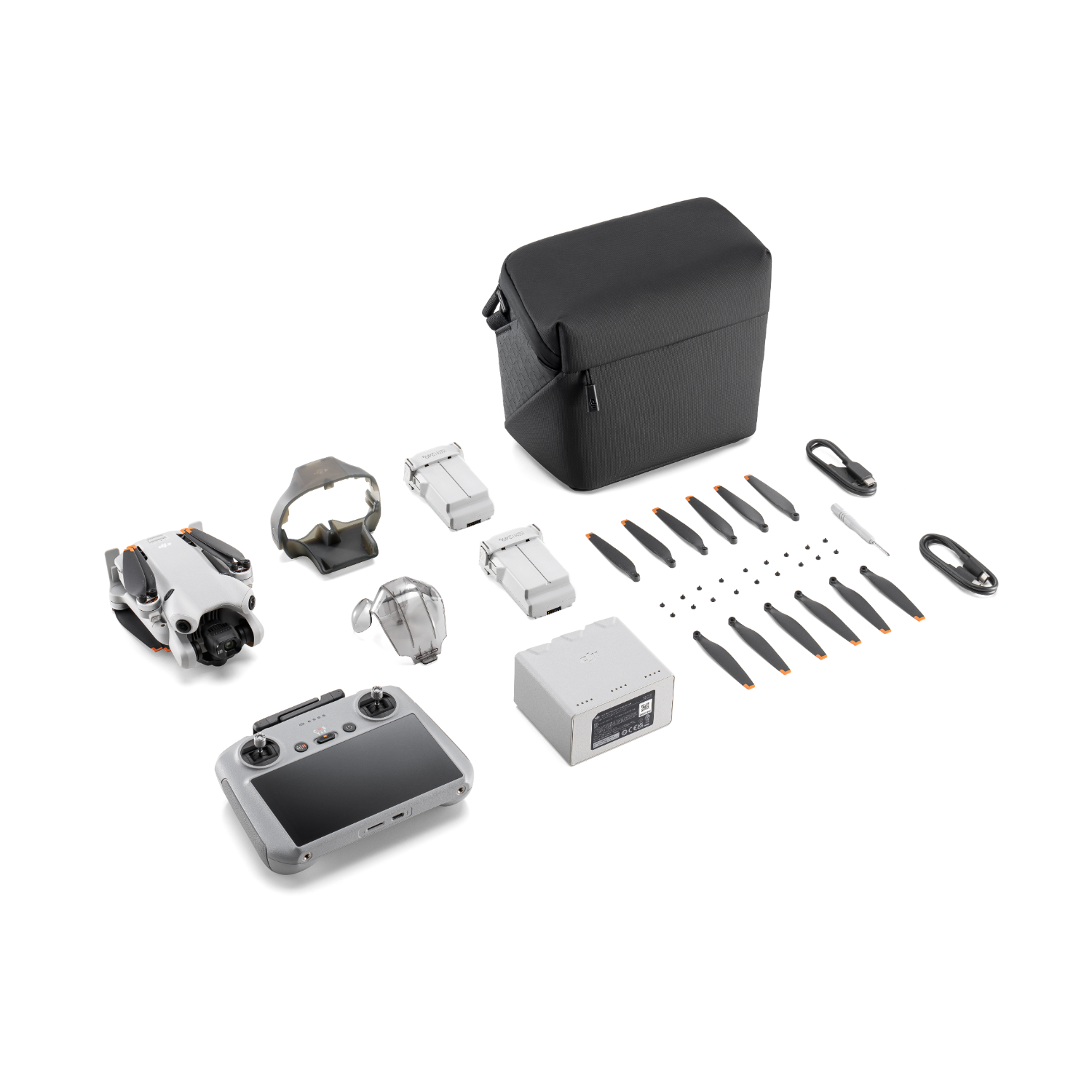 Zestaw drona. Zawiera drona, kontroler, baterie, śmigła i torbę transportową.