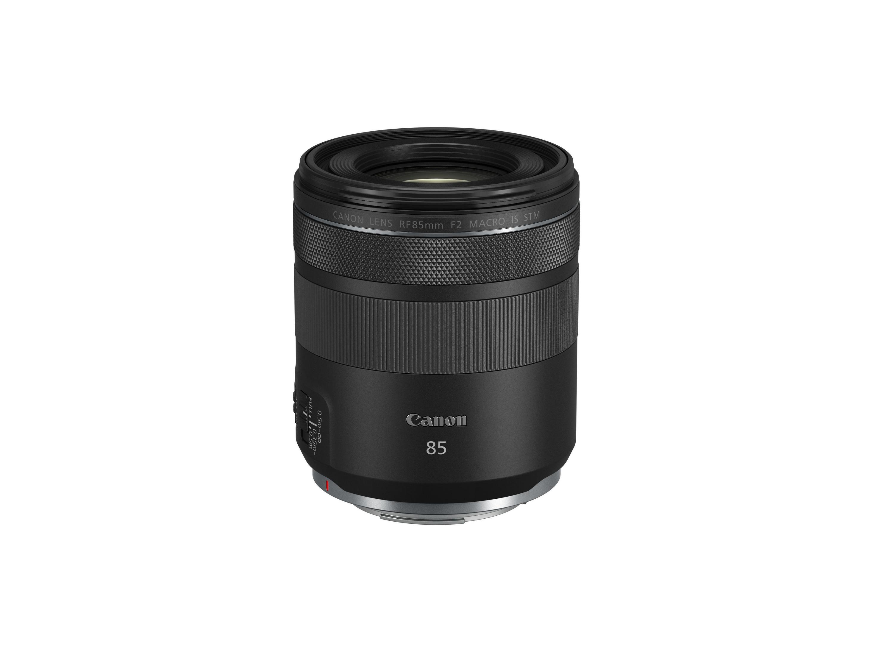 Black camera lens with markings, the lens is cylindrical and sits against a white background.