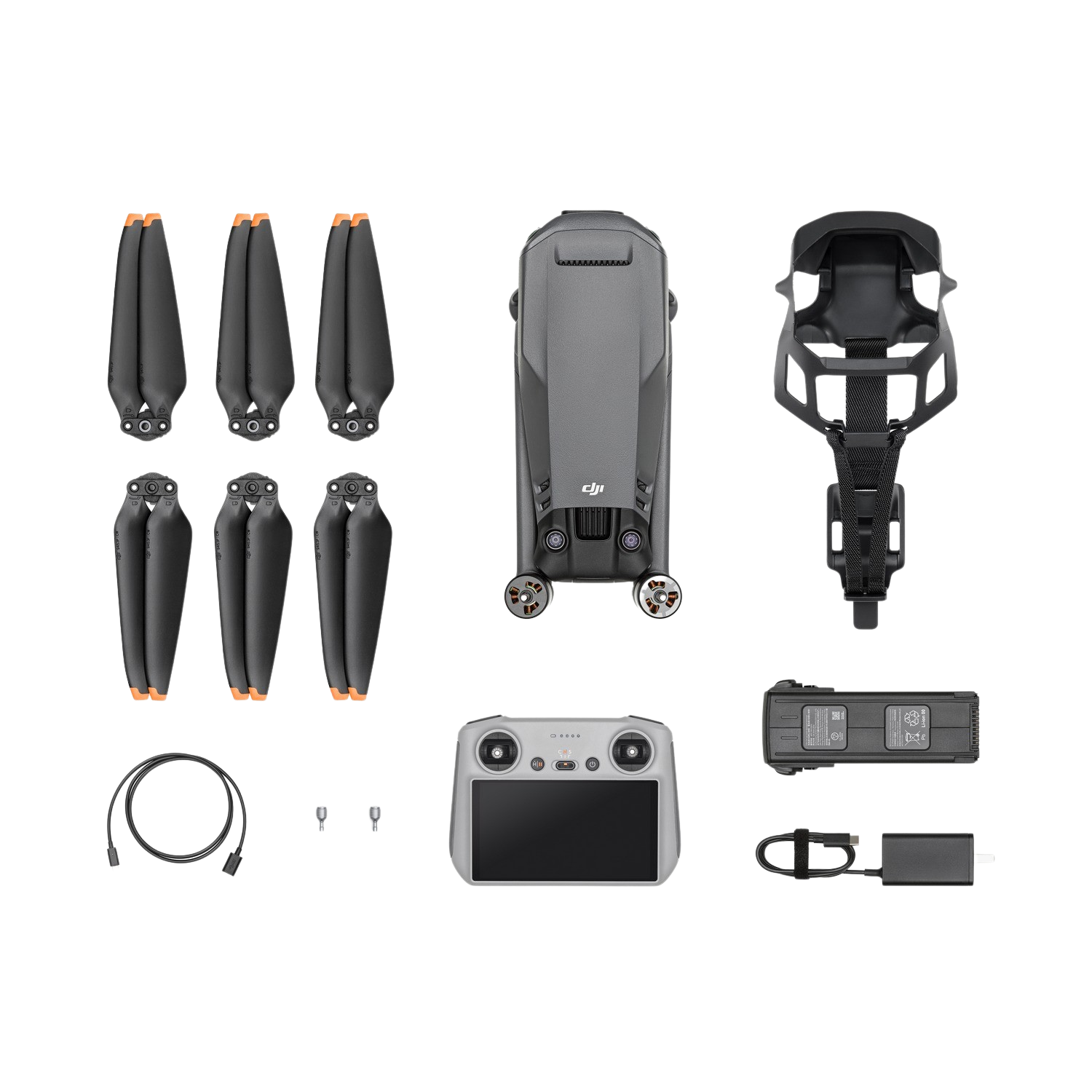 Kit de dron con hélices, controlador y accesorios sobre fondo negro.
