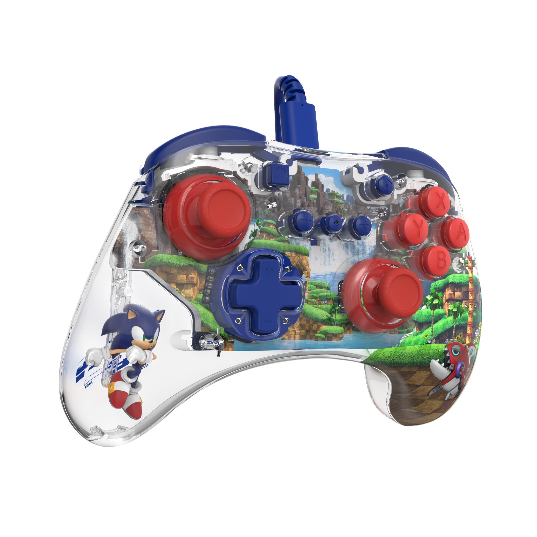Przezroczysty kontroler do gier z grafiką Sonic. Czerwone przyciski i niebieski d-pad. Niebieskie i czerwone akcenty.