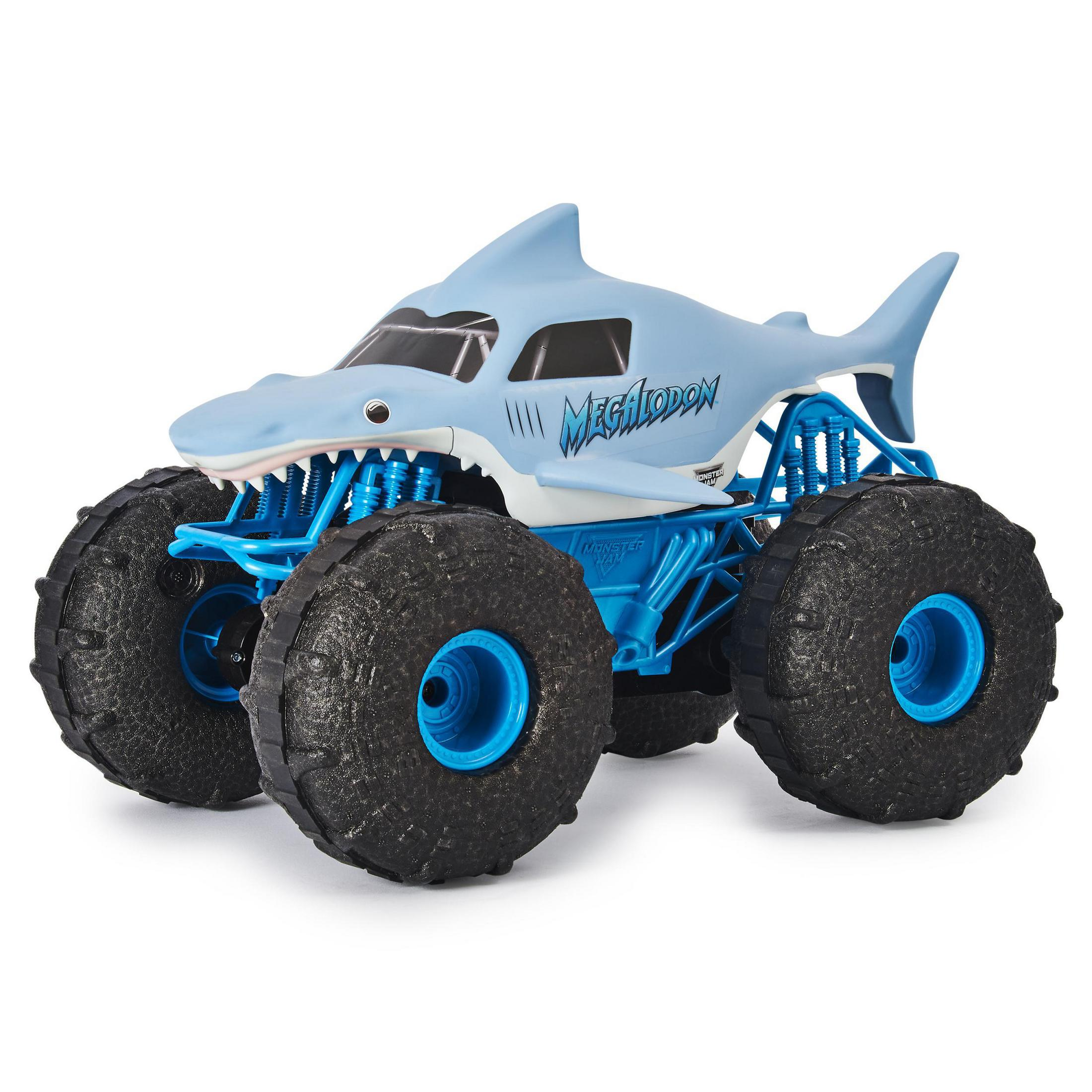 Niebiesko-biały monster truck Megalodon. To rekin z dużymi kołami i niebieską ramą.