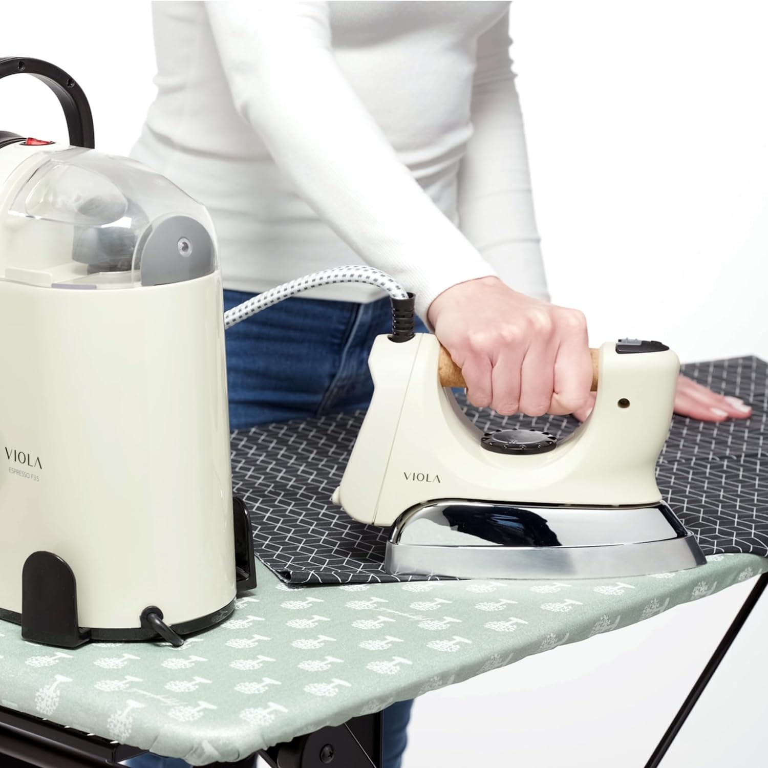 Frau bügelt auf einem Bügelbrett, mit einem Dampfgenerator an der Seite.