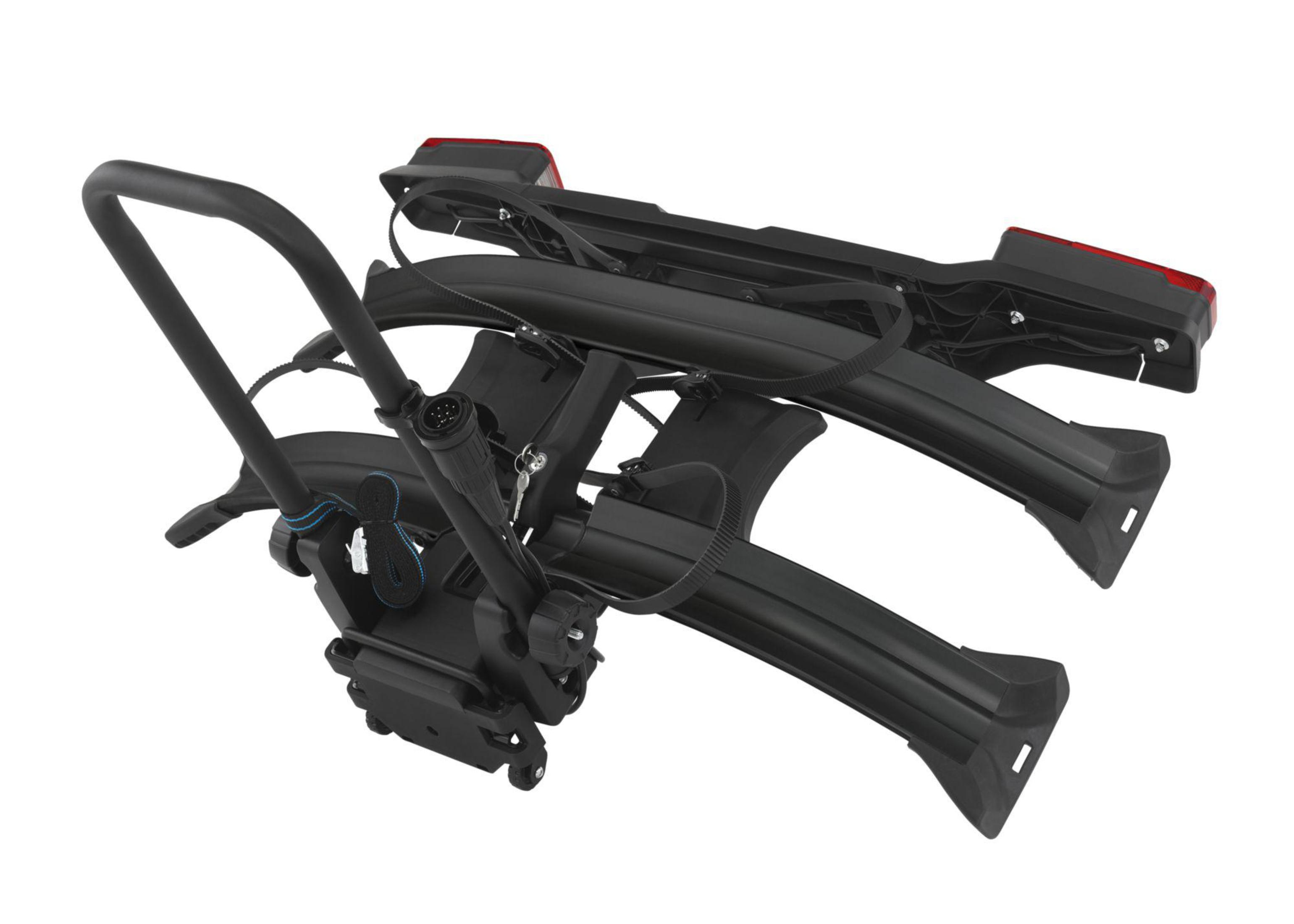 Ein schwarzer Fahrradträger zusammengeklappt, der den Montagemechanismus und die roten Lichter zeigt. Auf weißem Hintergrund.