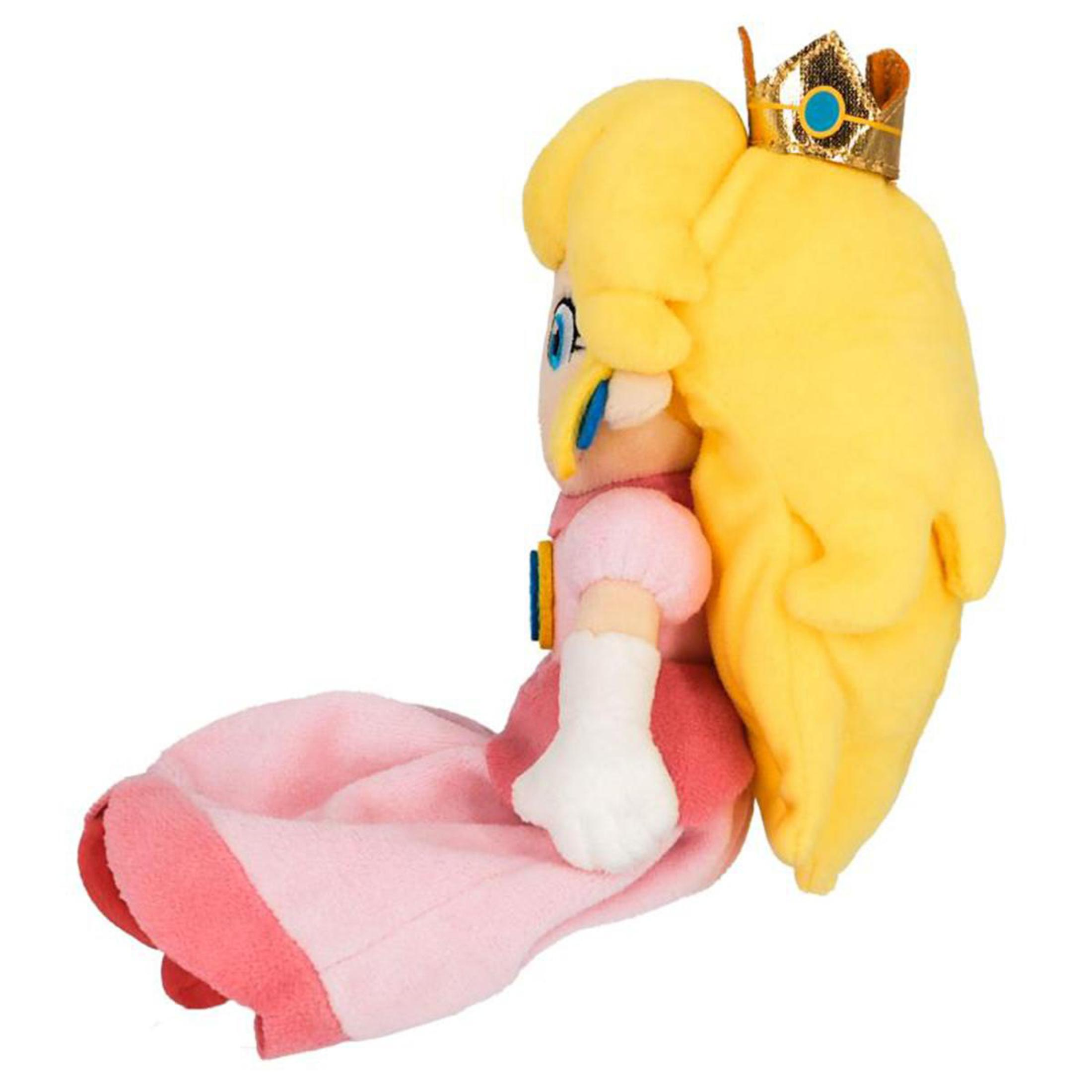 Eine Seitenansicht eines Princess Peach Plüschtiers mit Krone und rosa Kleid.