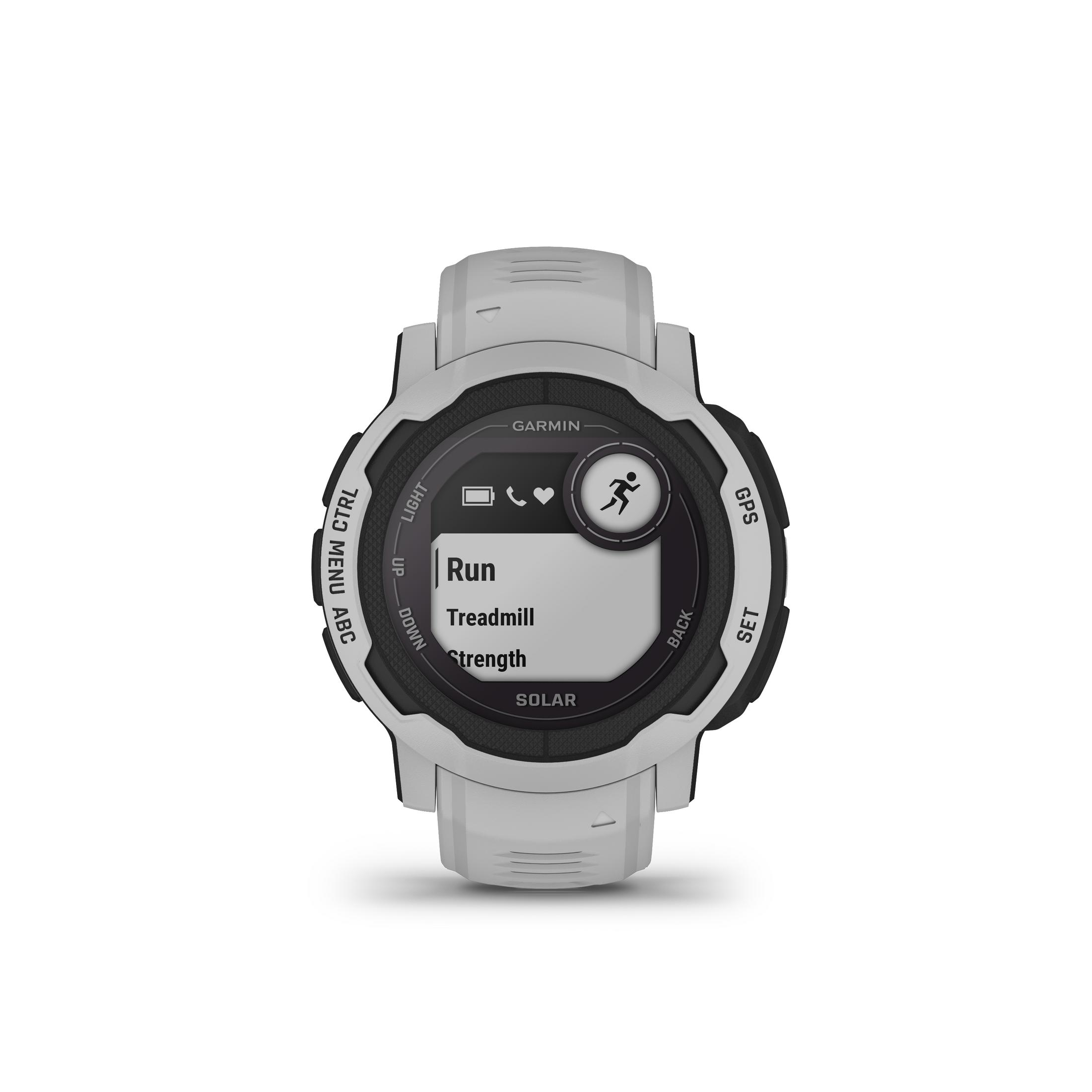 Eine weiße Garmin-Uhr zeigt die Optionen 'Laufen', 'Laufband' und 'Kraft'.