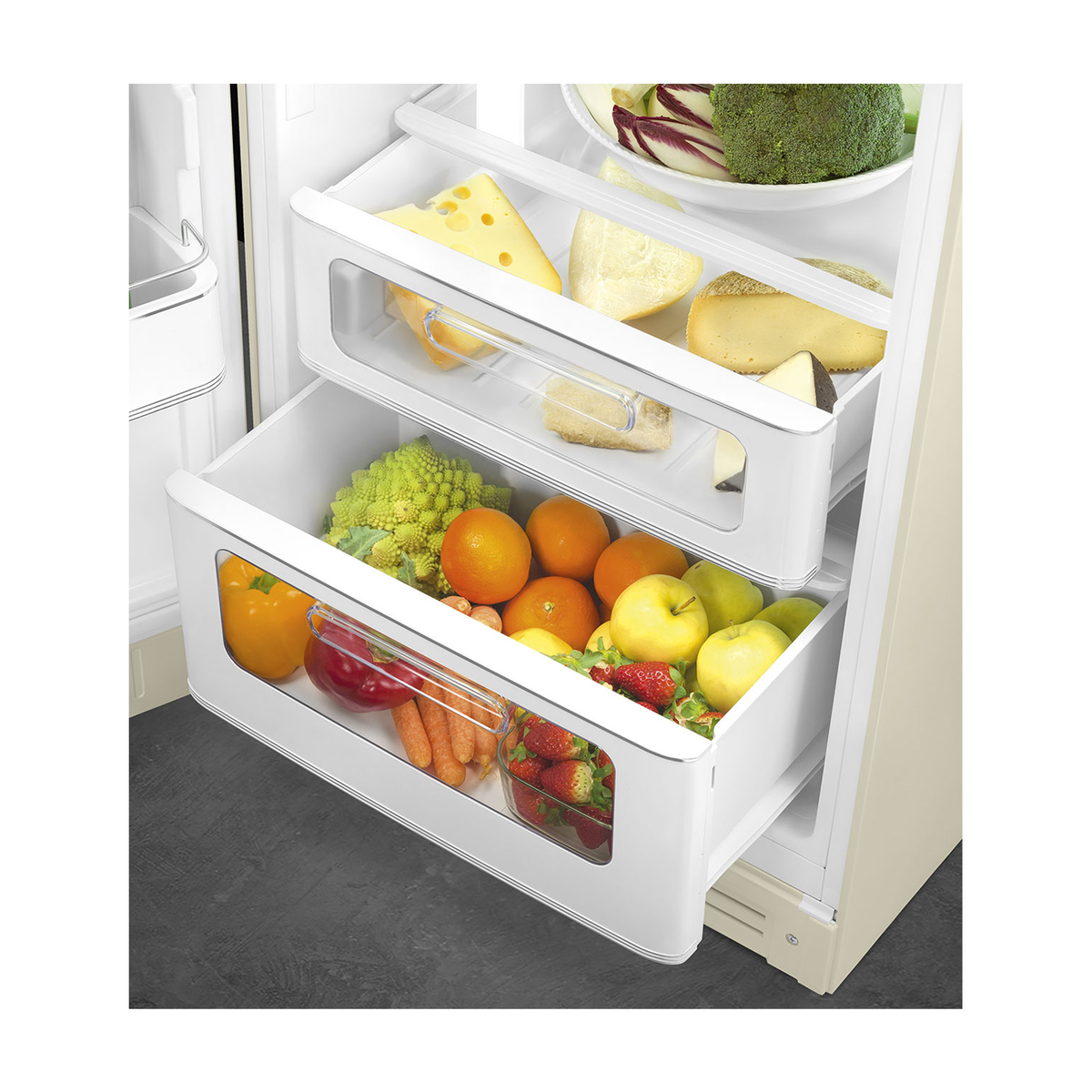 Un refrigerador con cajones llenos de frutas, verduras y queso. Tiene un interior blanco.