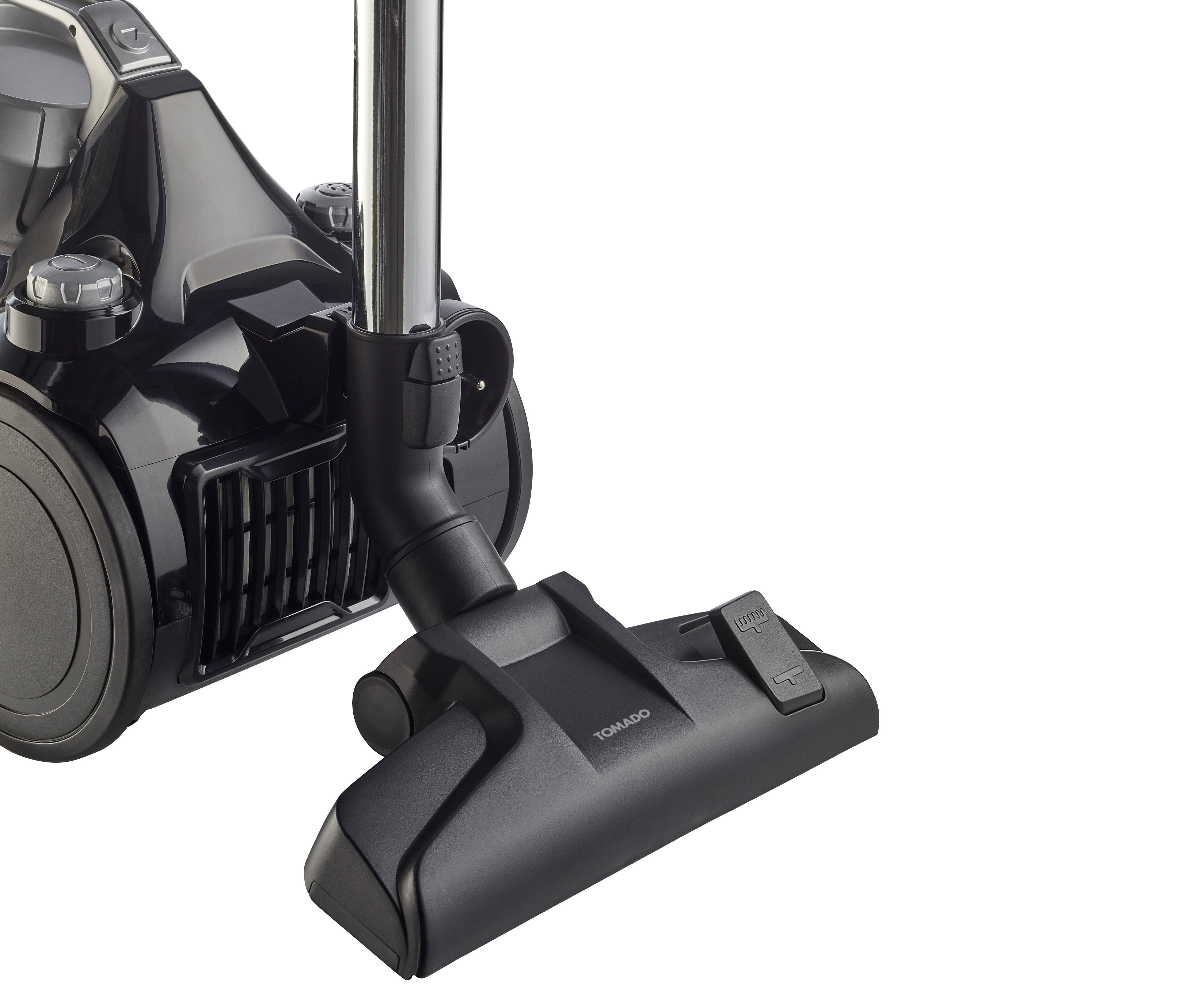Black vacuum cleaner, close-up. The nozzle and handle are in focus. White background.