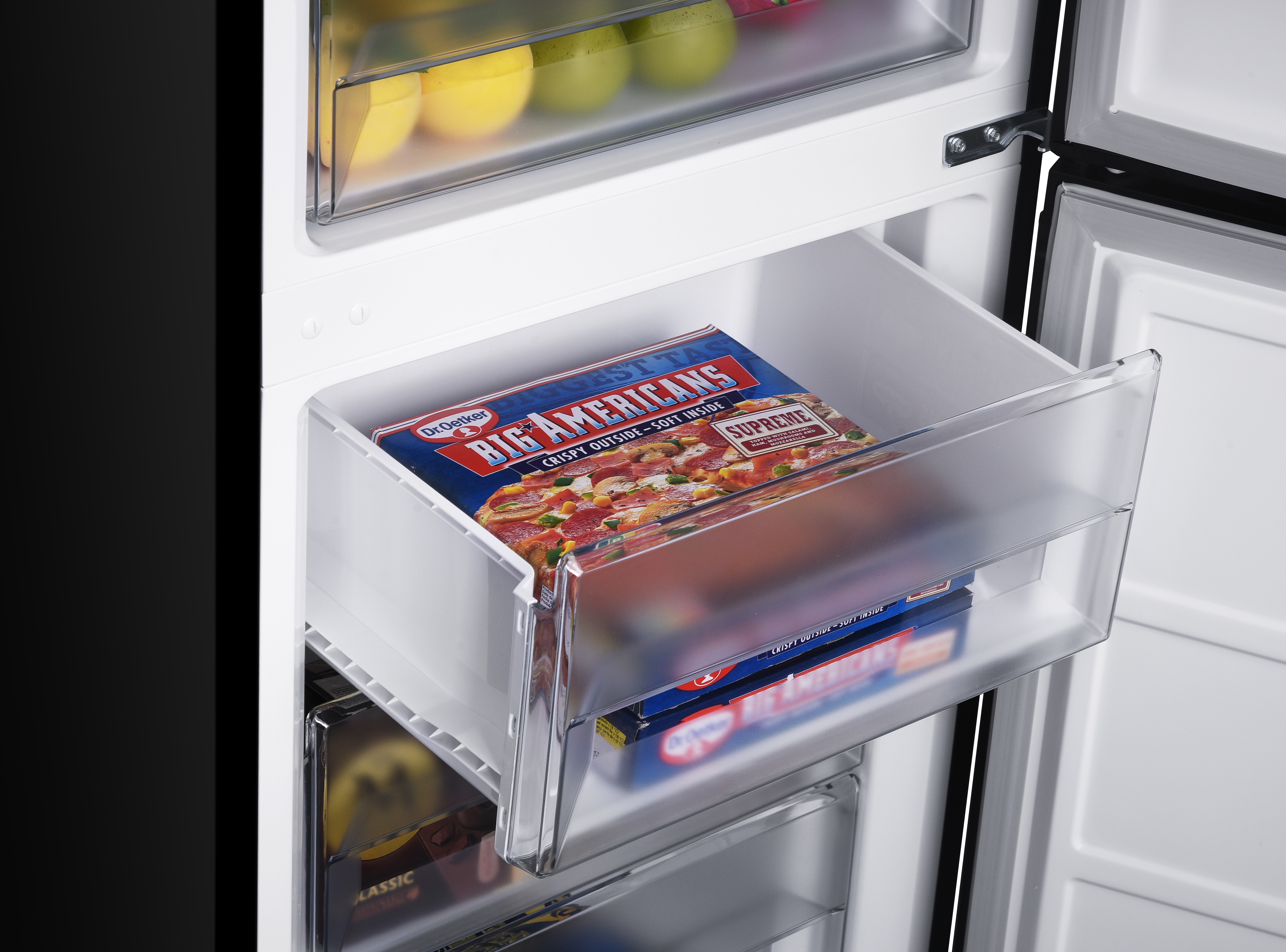 A freezer drawer with frozen pizza boxes inside. The drawer is transparent.