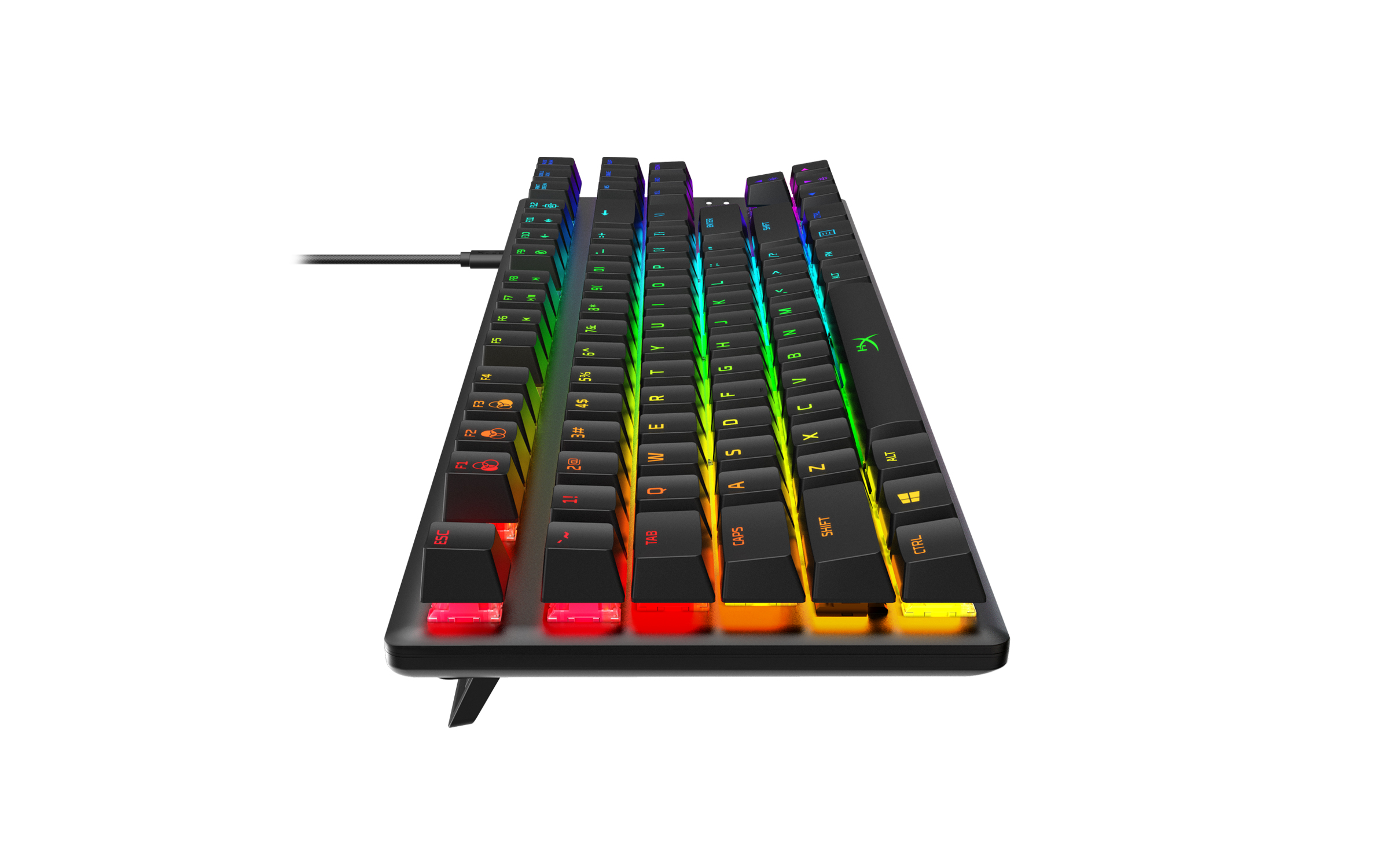Teclado gaming negro con teclas retroiluminadas de colores. Vista en ángulo sobre una superficie blanca.