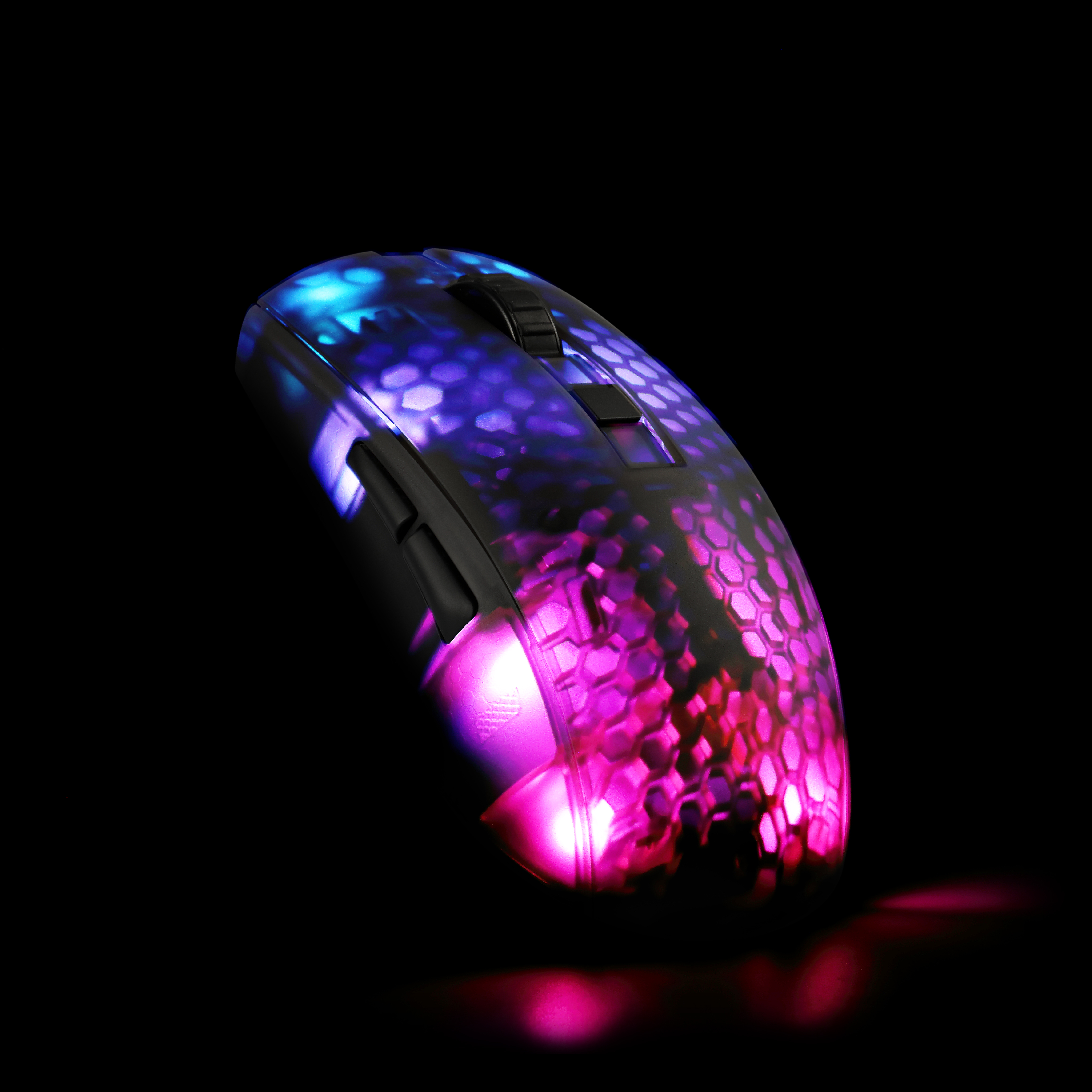 A gaming mouse with a honeycomb pattern, lit with multiple colors on a black background.