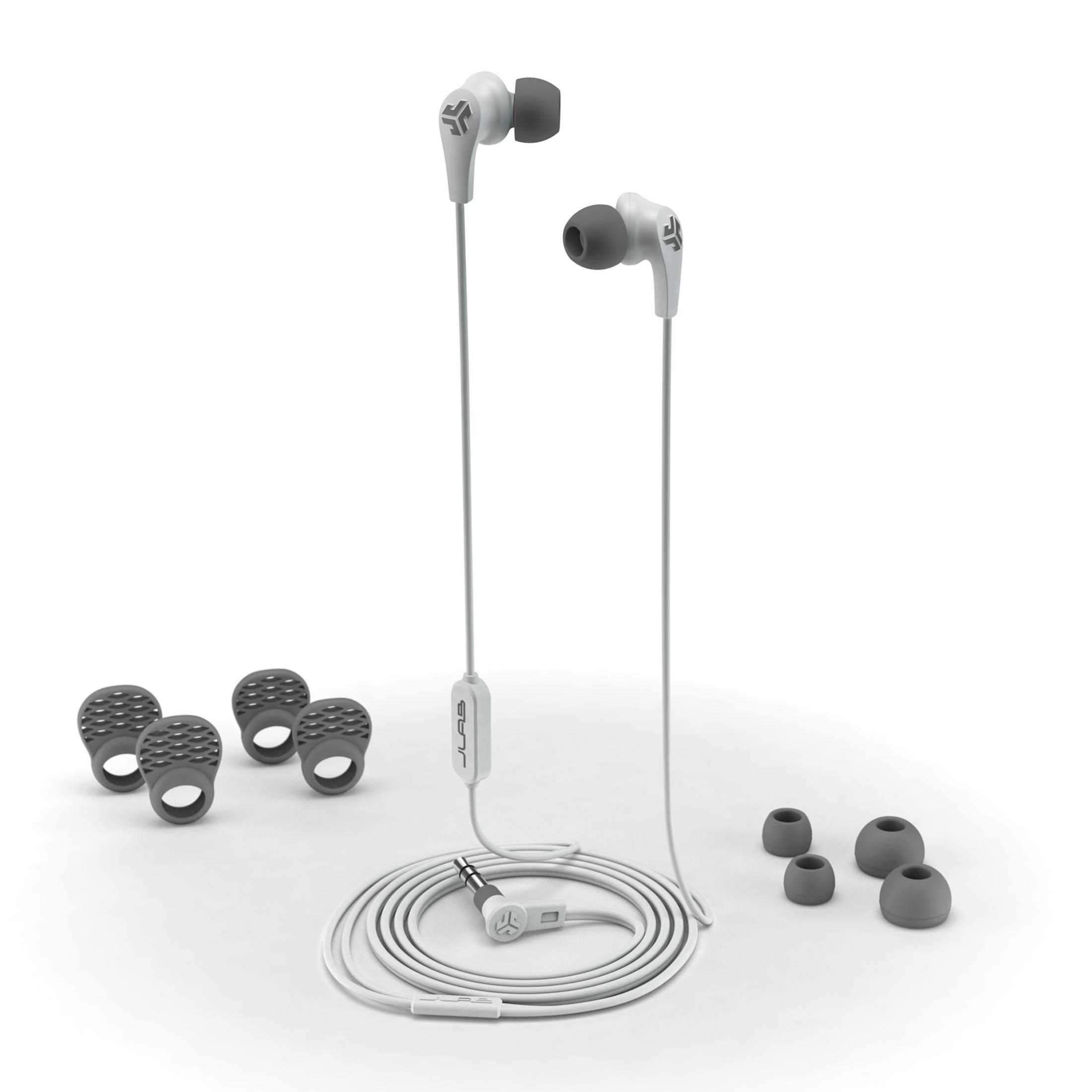 Auriculares blancos con almohadillas grises y puntas adicionales. También son visibles un cable blanco con una caja de control y un conector de 3,5 mm.