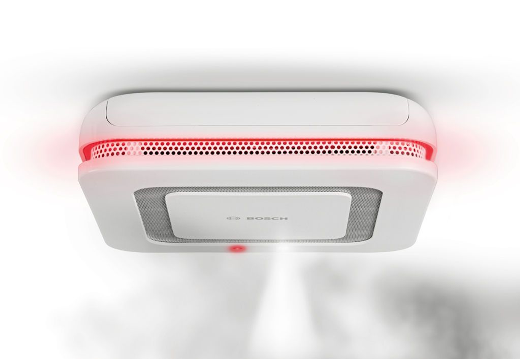 Biała czujka dymu z czerwonym pierścieniem świetlnym, zamontowana na białym suficie, z logo Bosch.