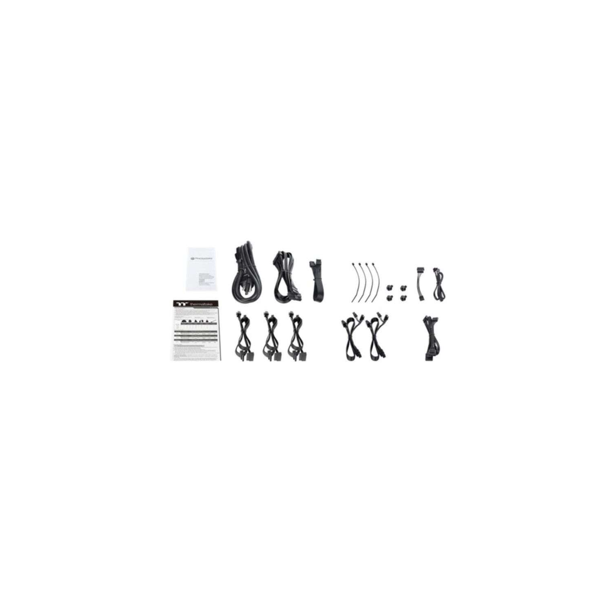 Computer parts. Various black cables, ties, and a manual are arranged on a white surface.
