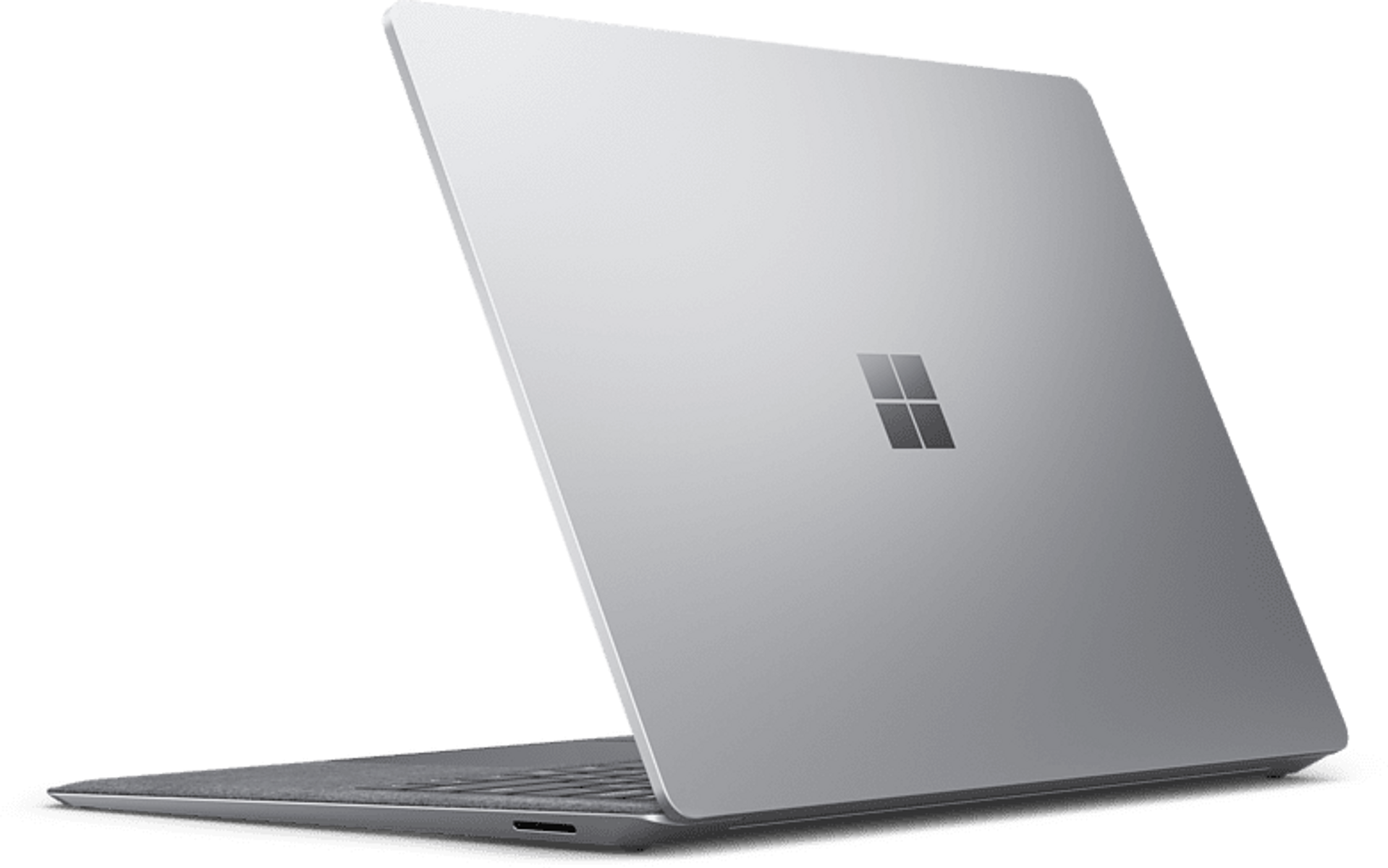 Silberner Laptop von hinten betrachtet. Ein Microsoft-Logo ist auf dem Deckel sichtbar. Der Bildschirm ist offen.
