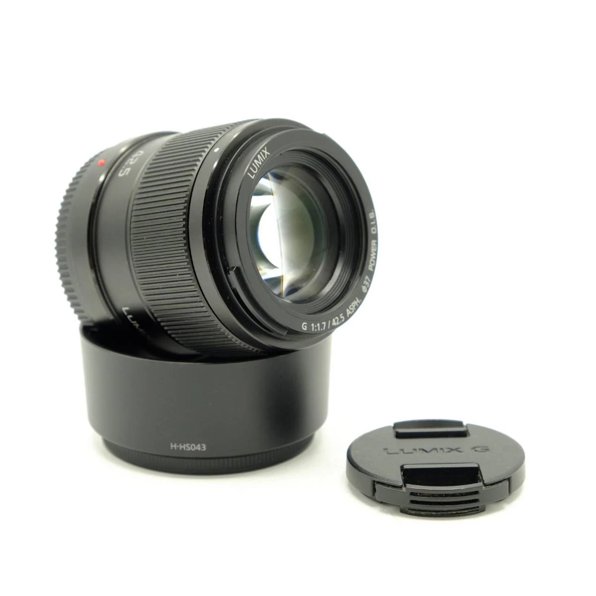 Czarny obiektyw z osłoną przeciwsłoneczną i dekielkiem, na białym tle.