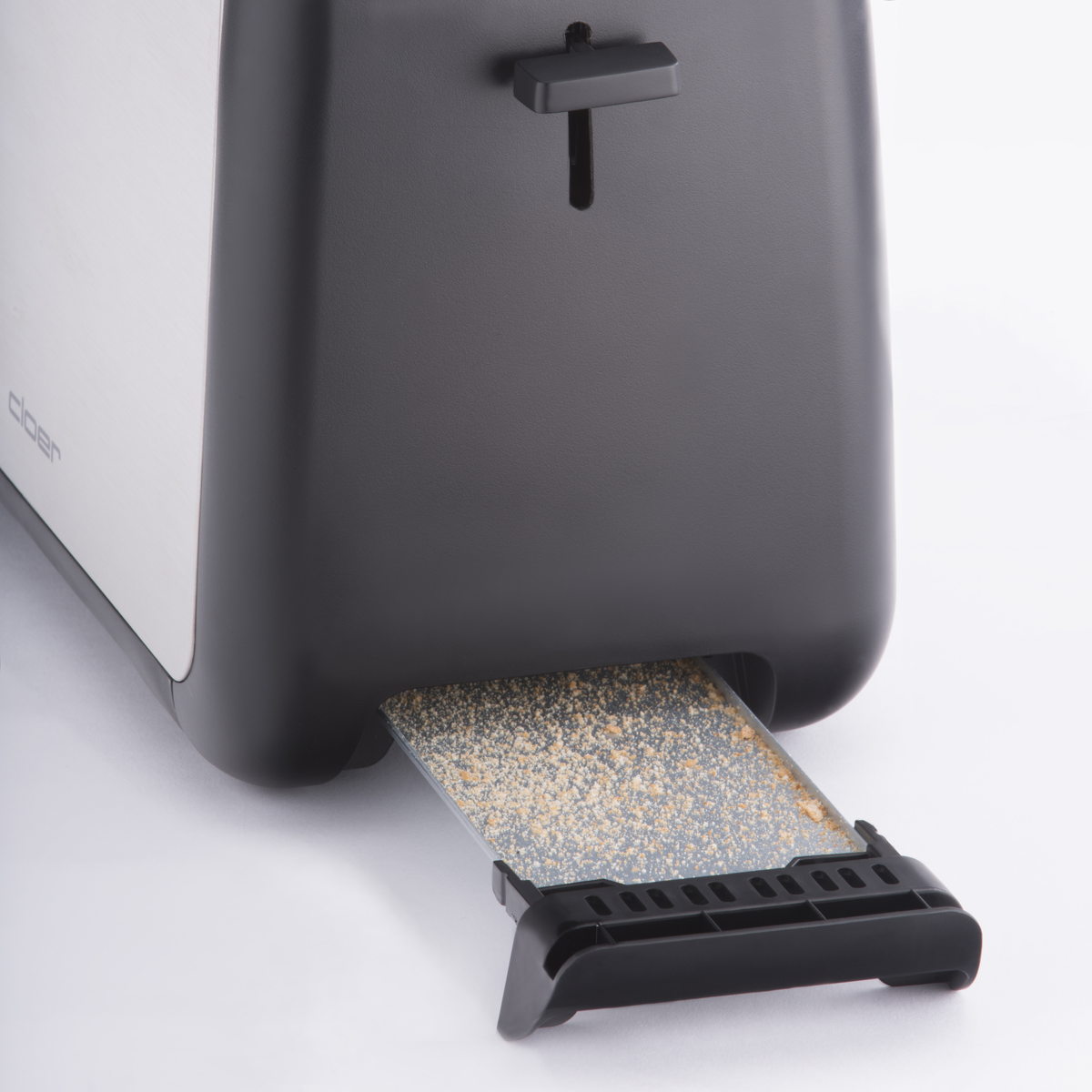 Dwukolorowy toster z okruchami i czarną dźwignią.